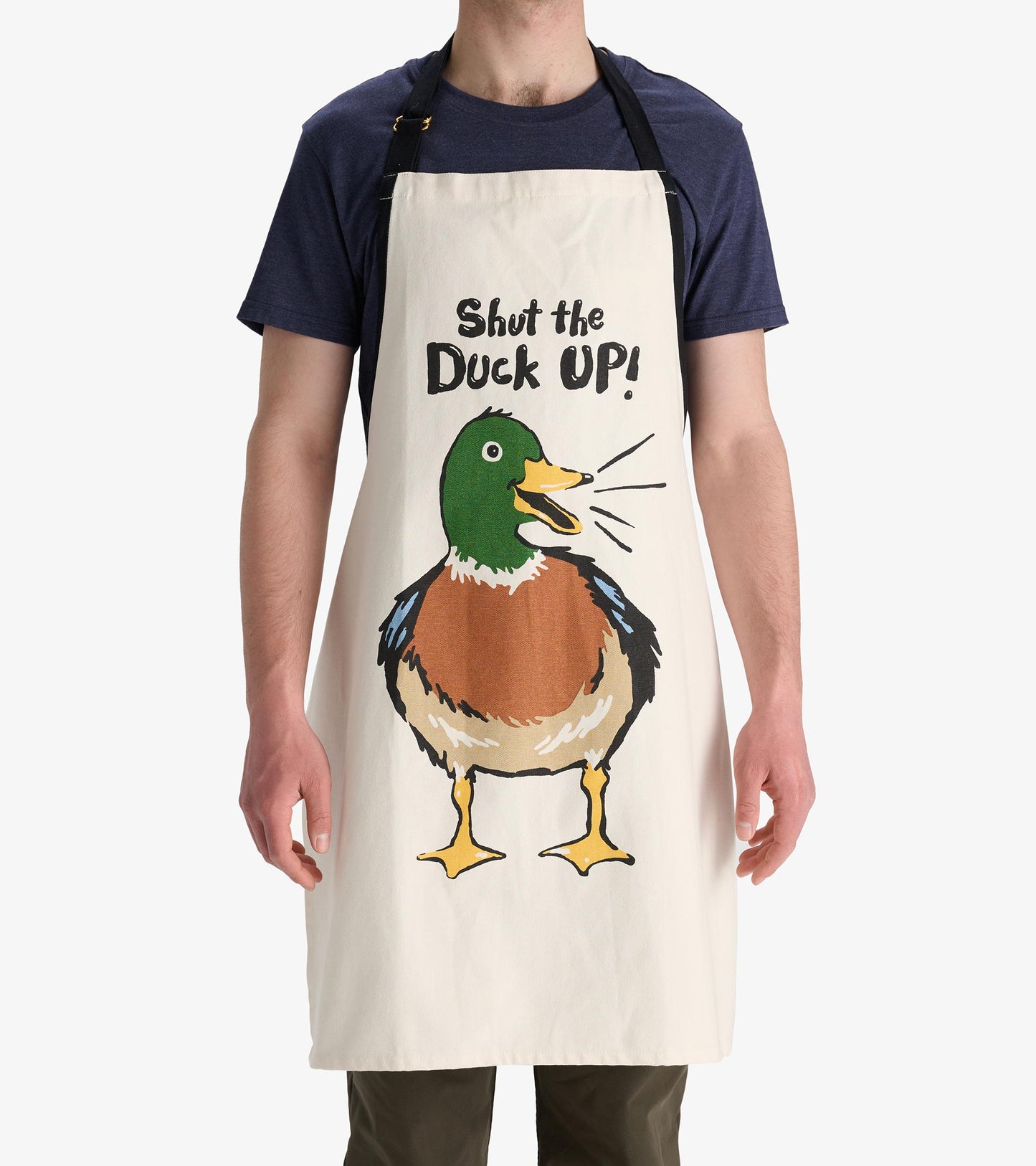 Cream apron featuring a colorful duck illustration and the phrase "Shut the Duck Up!" in bold text.
