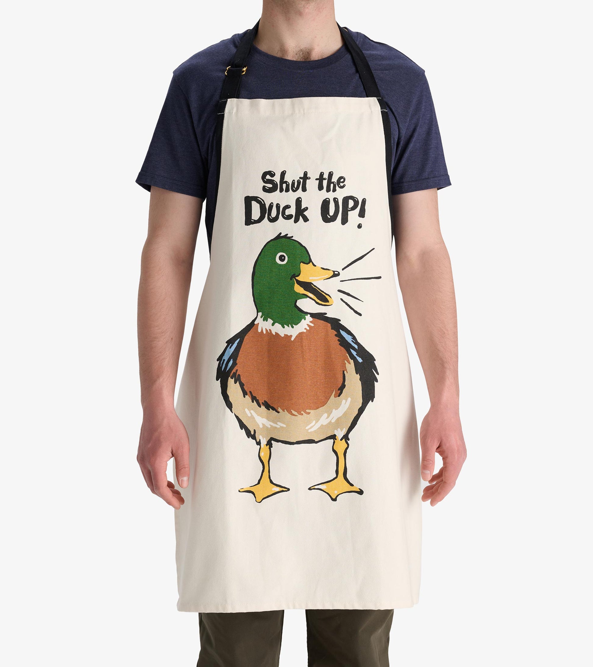 Cream apron featuring a colorful duck illustration and the phrase "Shut the Duck Up!" in bold text.