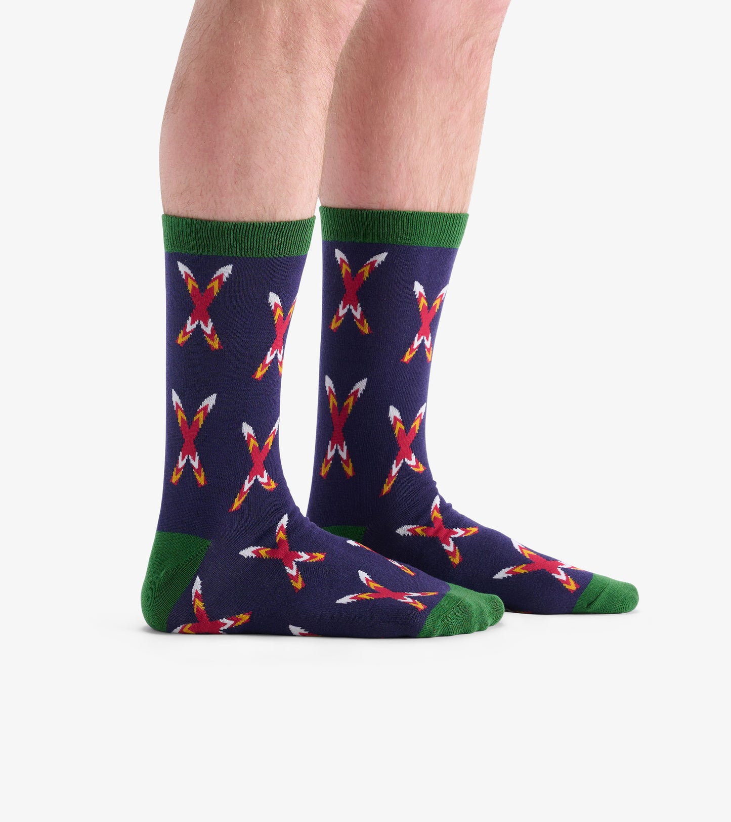 Navy socks with a crossed skis pattern in red and white, featuring green cuffs and heel, suitable for casual wear.