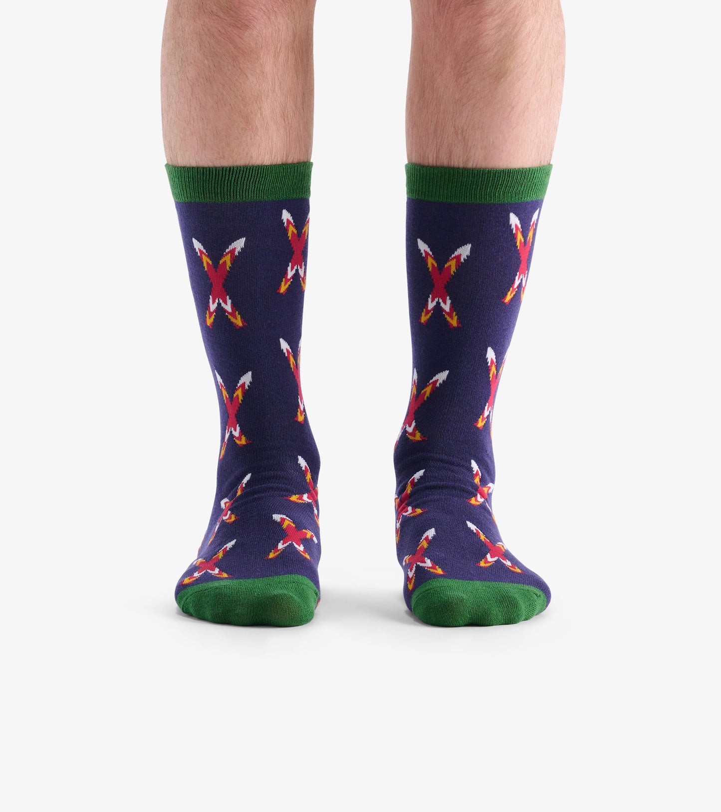 Navy socks featuring crossed skis pattern in red, white, and yellow, with green cuffs and soles. One size fits all.