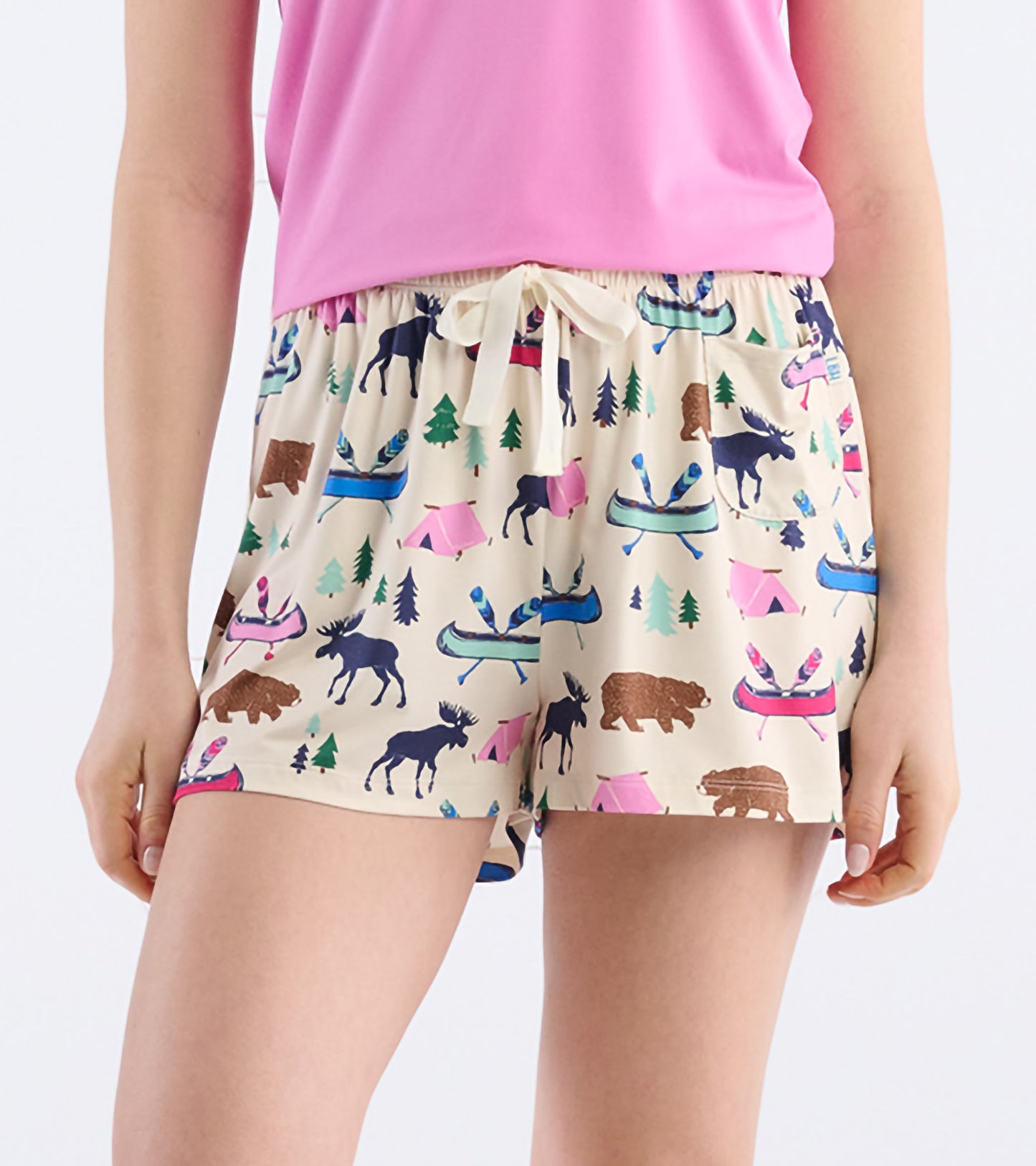 Beige pajama shorts featuring a colorful camping and wildlife print, with an elastic waistband and drawstring.