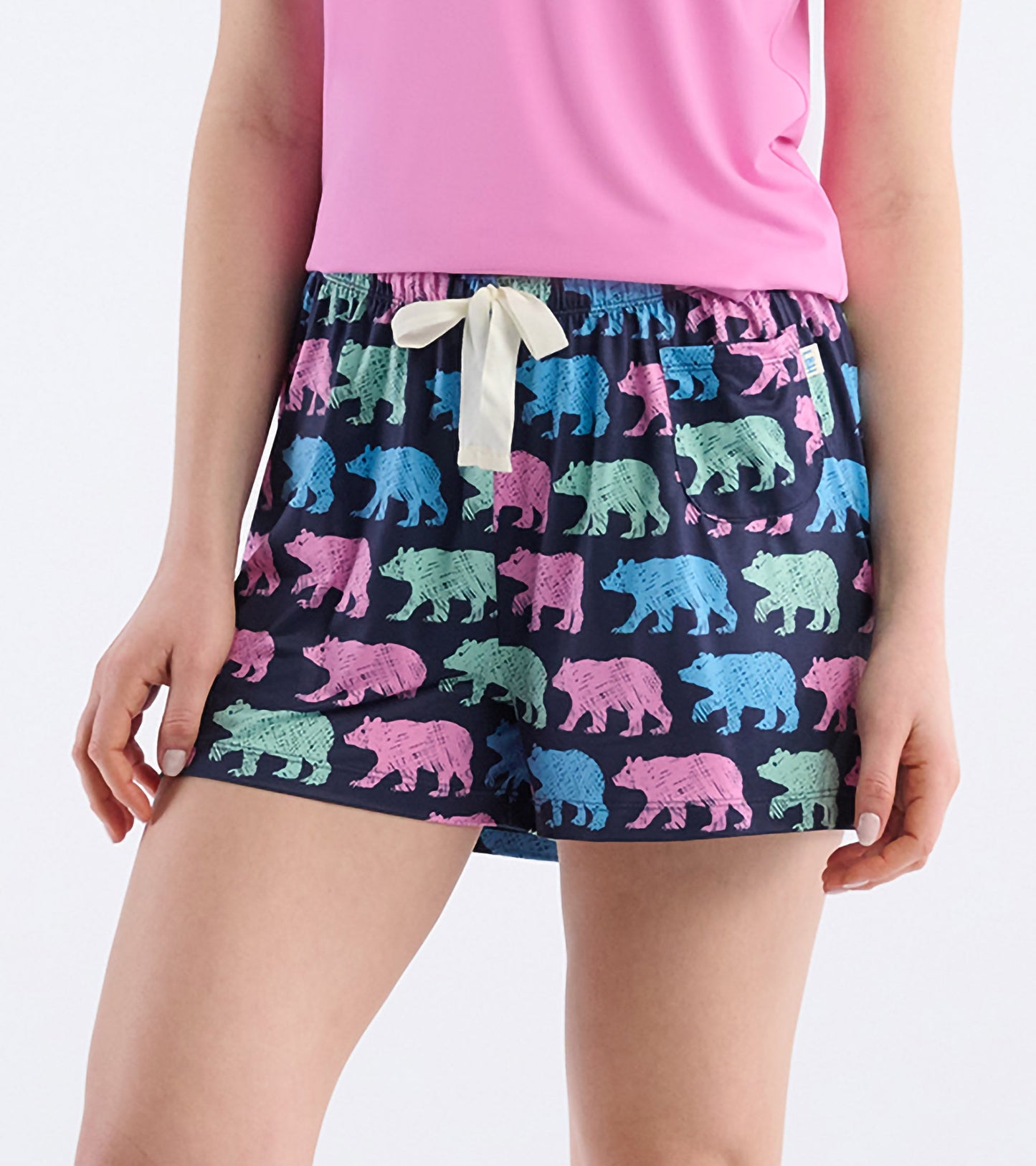Navy pajama shorts featuring colorful bear patterns, elastic waistband with drawstring, suitable for lounging or sleeping.