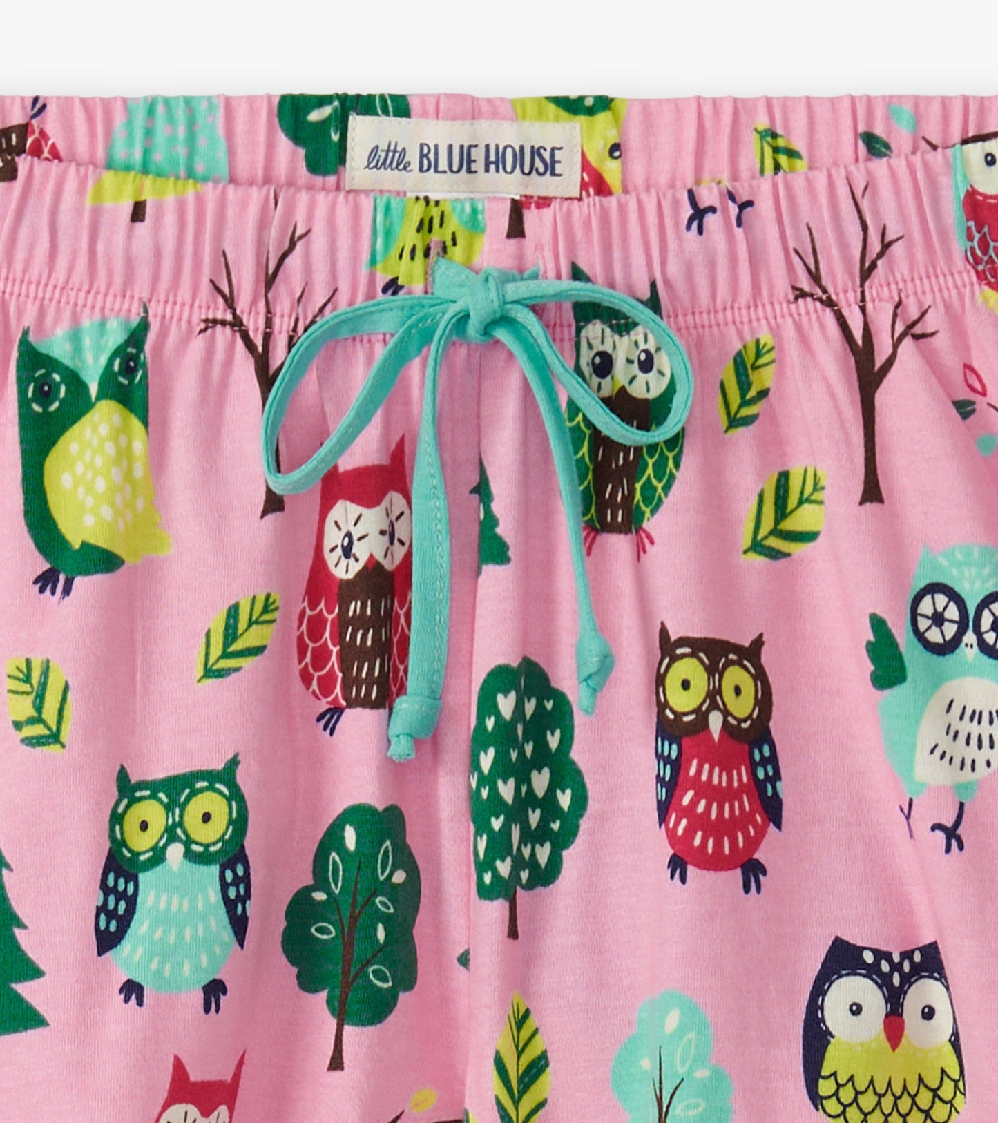 Pink cotton sleep shorts featuring a colorful owl and tree pattern, with an adjustable drawstring waistband.