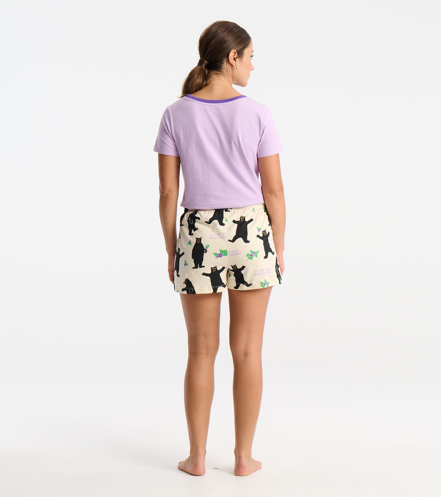 Women's cotton sleep shorts in cream with playful black bear and floral patterns, featuring an elastic waistband.