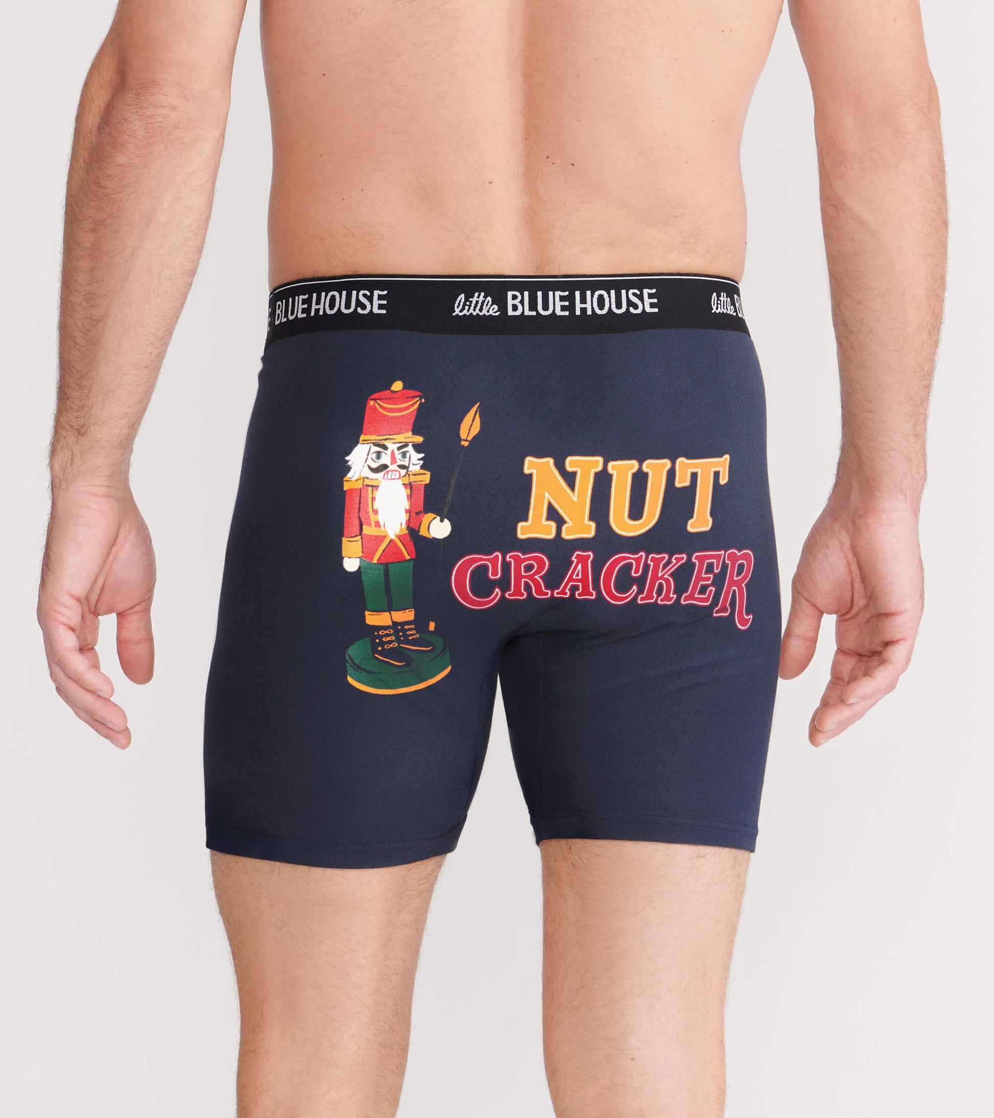 Navy boxer briefs featuring a nutcracker graphic and "NUT CRACKER" text on the back, with a comfortable elastic waistband.