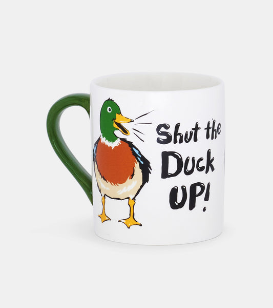 White ceramic mug with a green handle featuring a colorful duck illustration and the phrase "Shut the Duck Up!