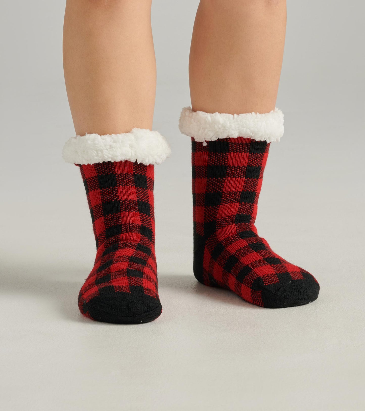 Red and black buffalo plaid women's cabin socks with a soft white sherpa lining at the cuff.