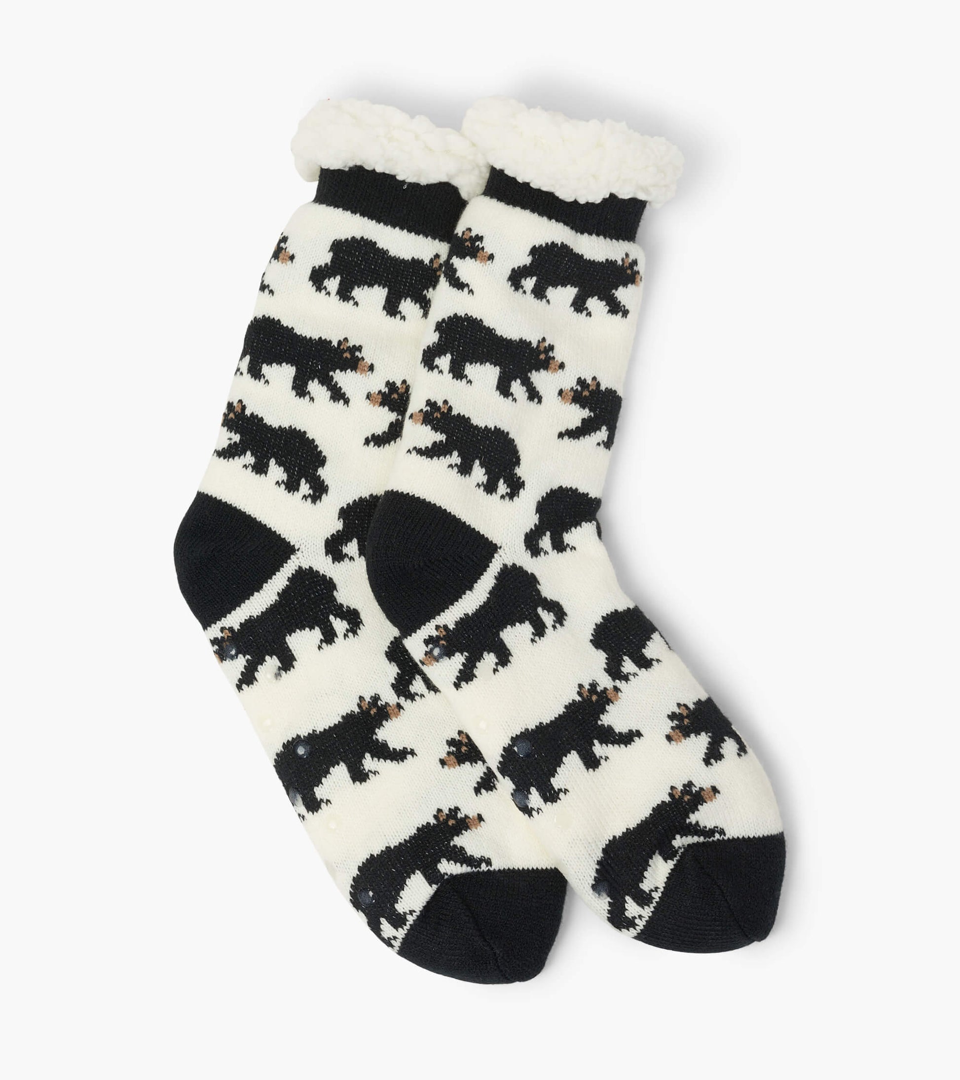Black and white cabin socks featuring a bear pattern with a fluffy cream cuff, designed for warmth and comfort.
