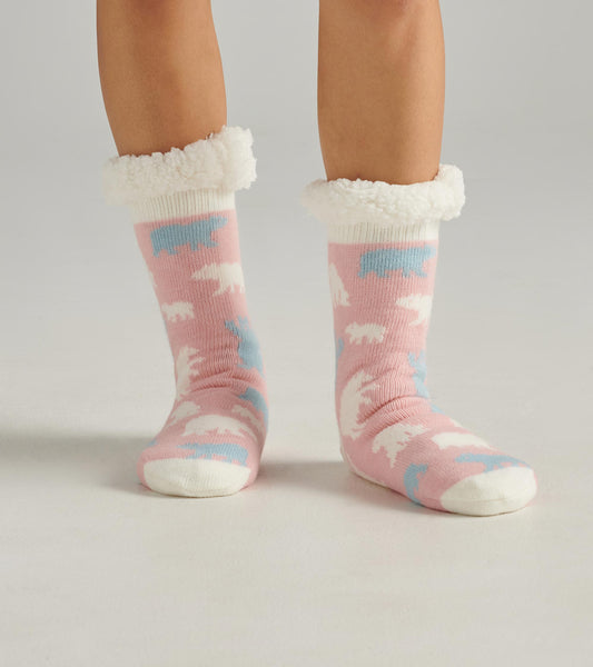 Pink cabin socks featuring polar bear patterns and a fluffy white sherpa lining at the cuff. One size fits all.