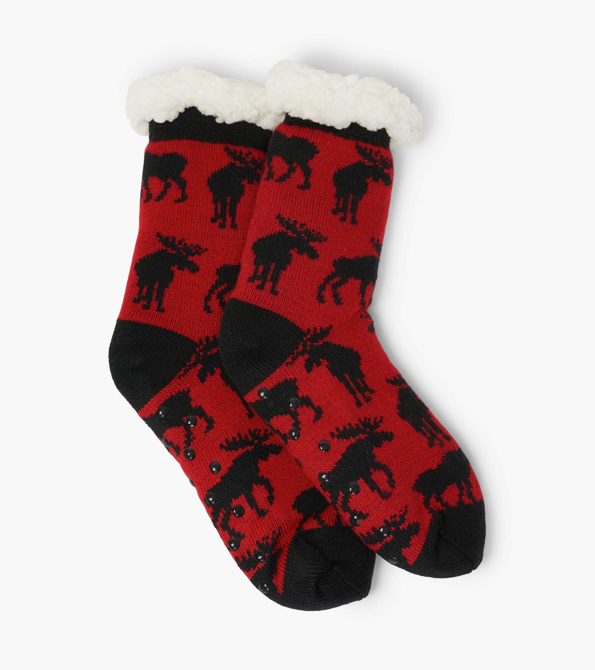 Red cabin socks featuring black moose patterns and a cozy white sherpa lining at the cuff. One size fits all.