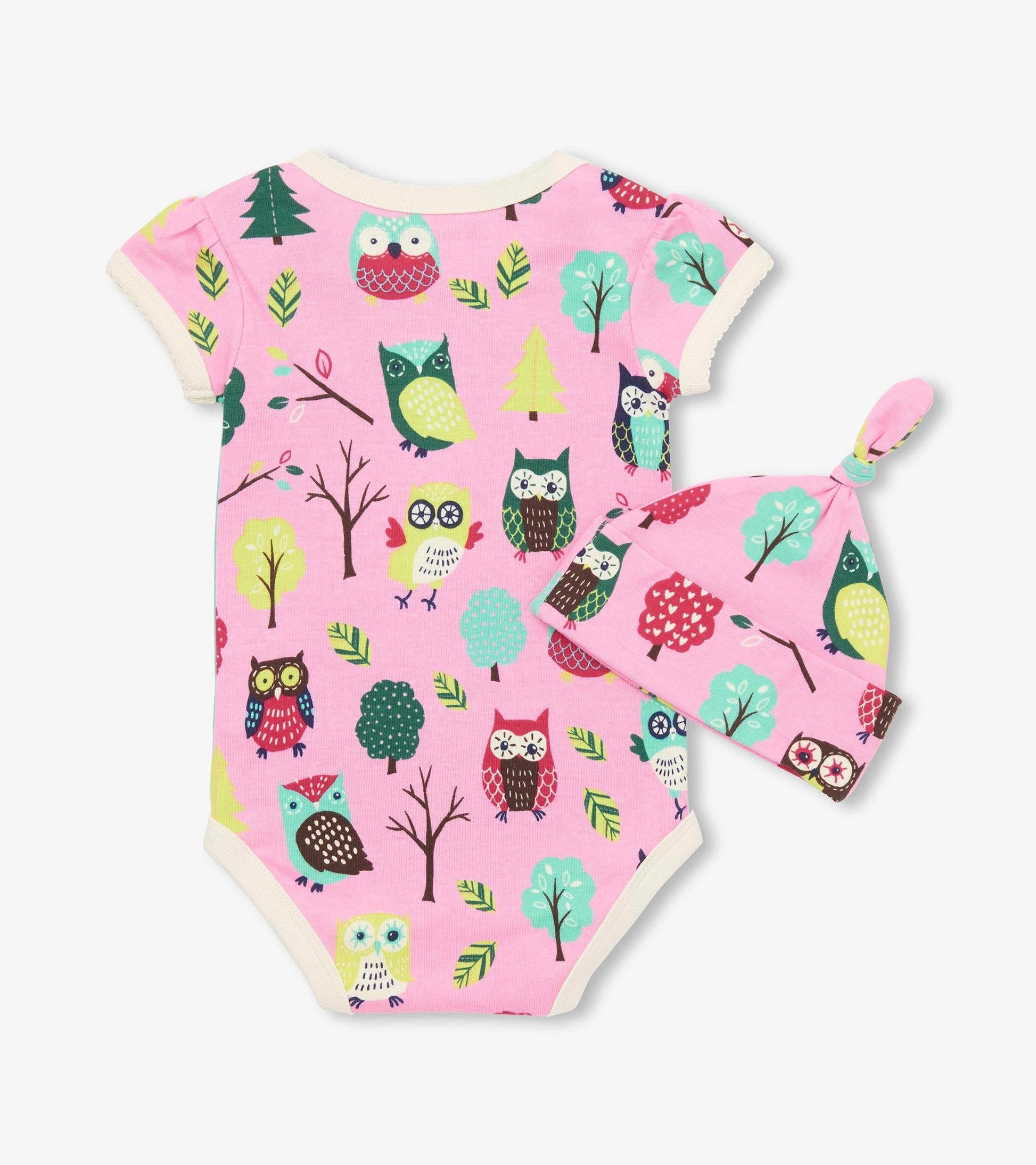 Pink bodysuit with owl and tree patterns, paired with a matching hat featuring a knot top. Suitable for infants.