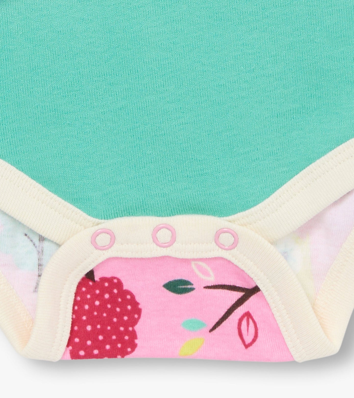 Turquoise bodysuit with a colorful floral print and cream trim, featuring snap closures at the bottom.