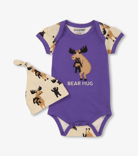 Purple bodysuit with moose graphic and cream hat featuring bear print, suitable for baby girls.