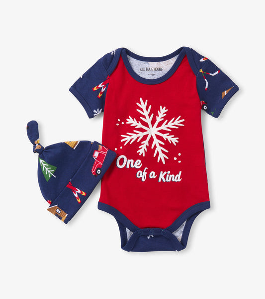 Red baby bodysuit with snowflake design and navy sleeves, paired with a matching hat featuring a festive pattern.