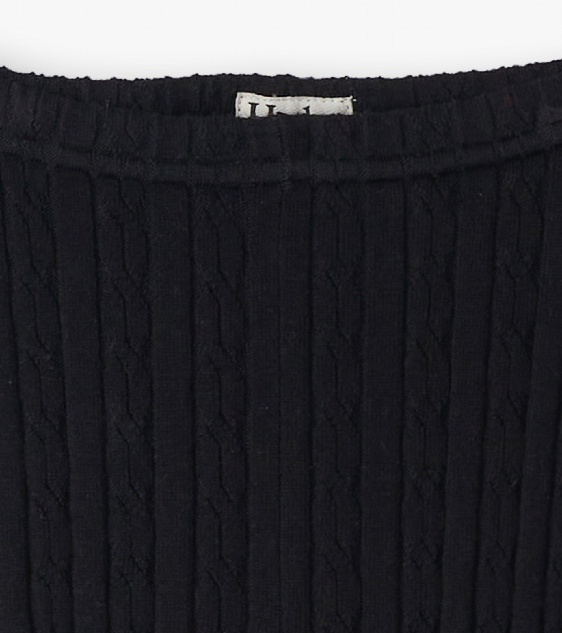 Black cable knit leggings with a textured pattern, featuring a stretchy waistband for comfort.