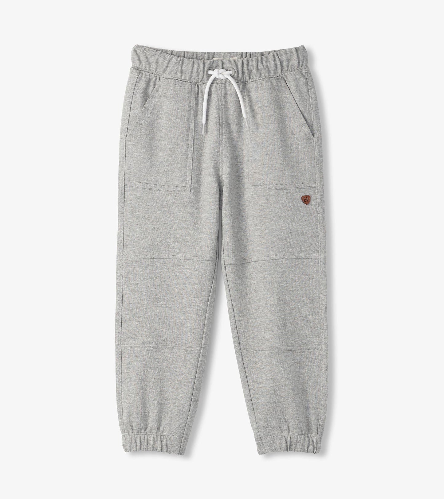 Grey cozy pants with an elastic waistband, drawstring, and side pockets, featuring a tapered leg design.