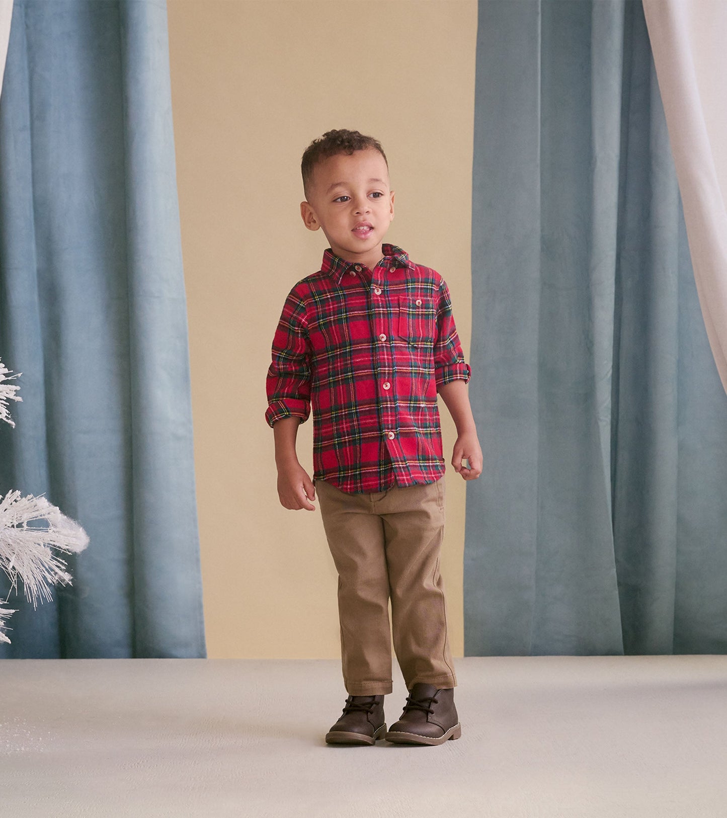 Khaki twill pants for babies, featuring a classic fit and soft fabric, paired with a red plaid shirt and brown boots.