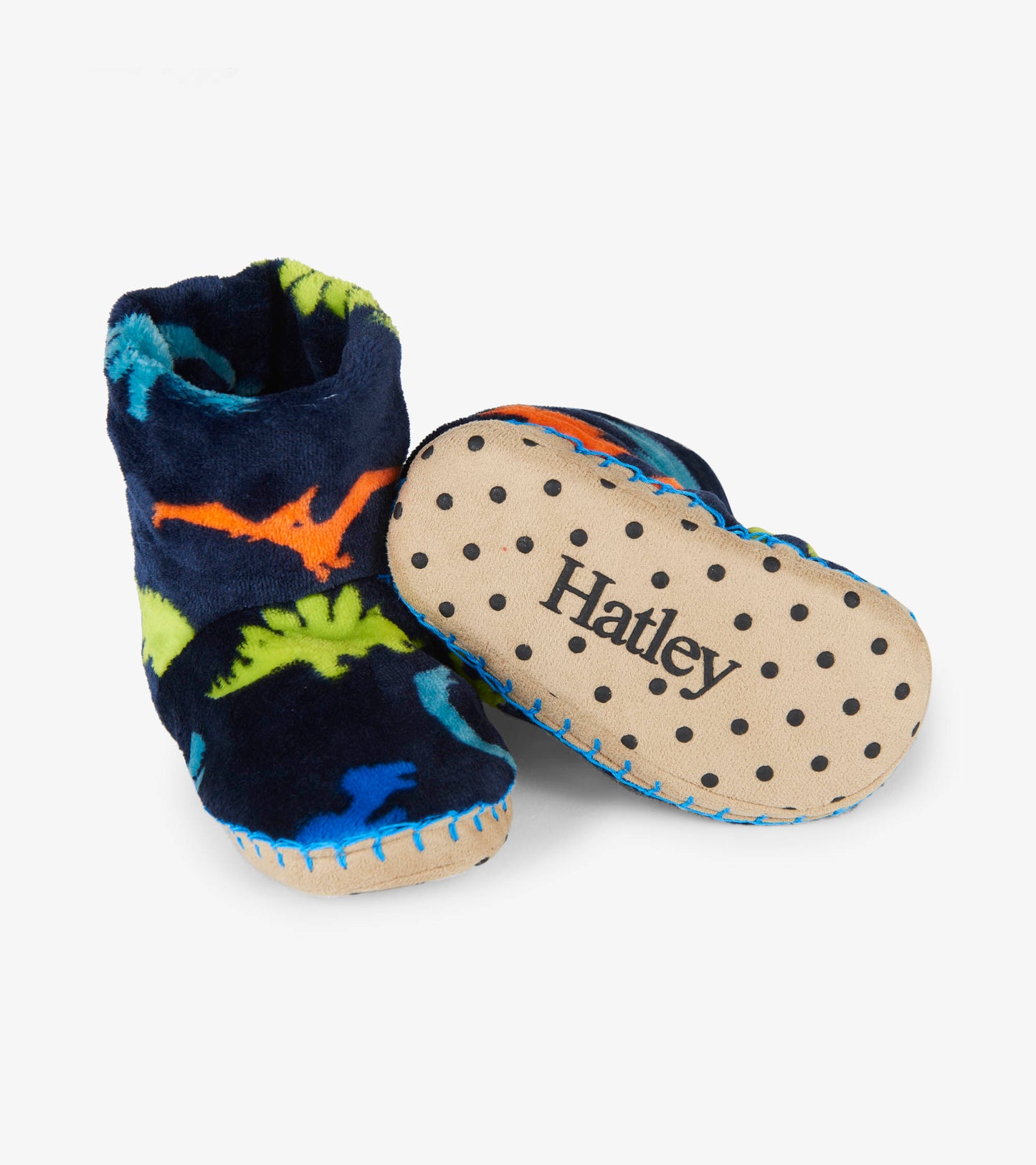 Navy fleece slippers featuring colorful dinosaur patterns and a soft, dotted sole for comfort.