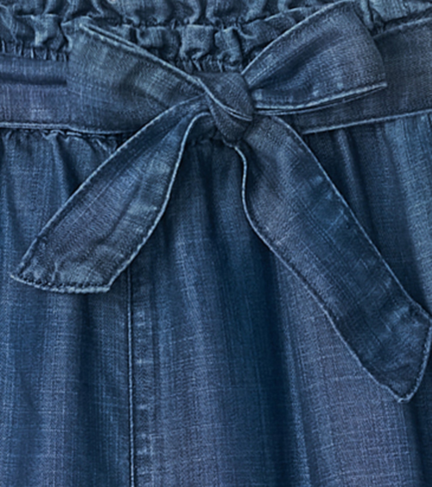 Dark blue textured Tencel paperbag pants featuring a gathered waistband and a tied belt detail.