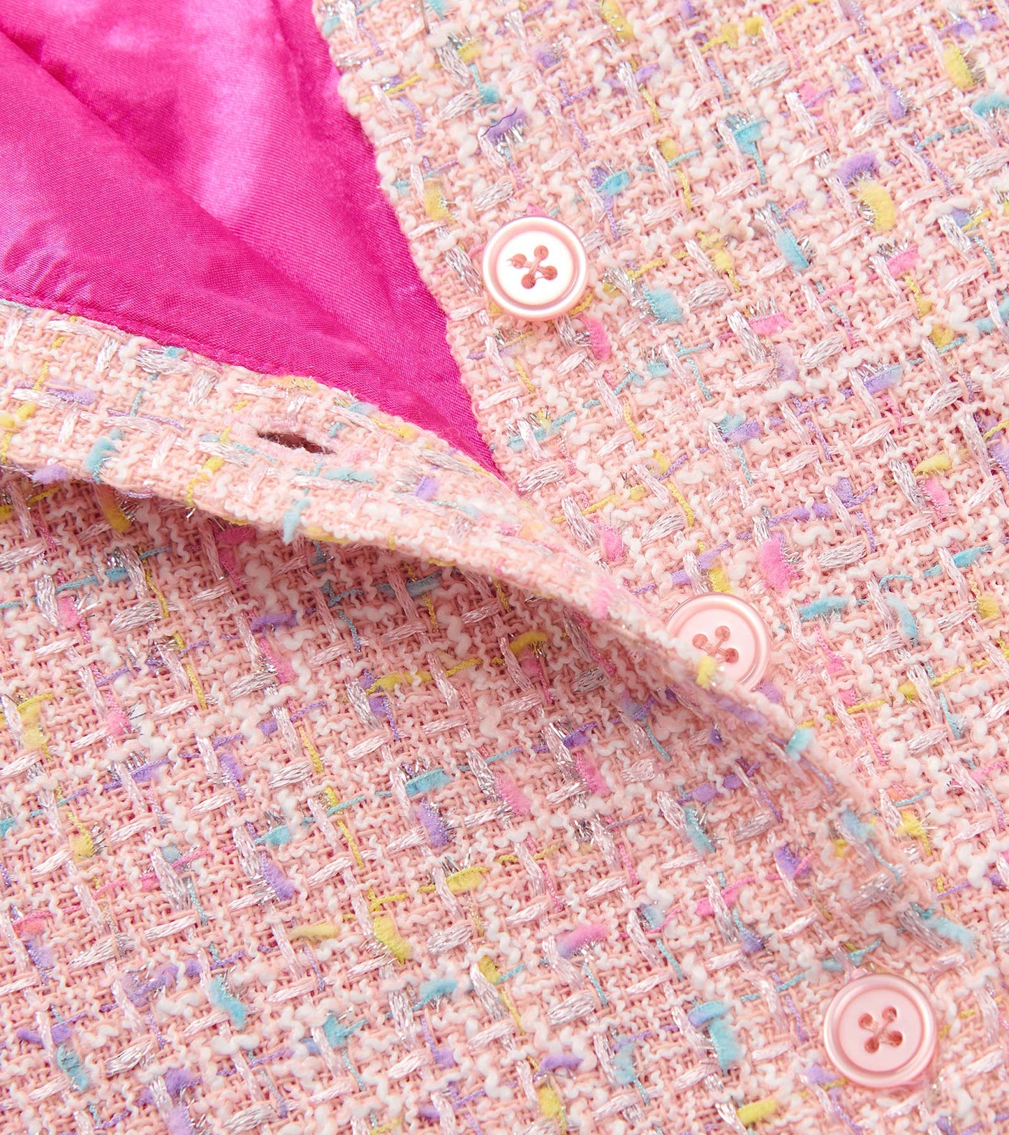 Aurora pink tweed dress with faux fur trim, featuring colorful specks and pink satin lining, showcasing button detail.