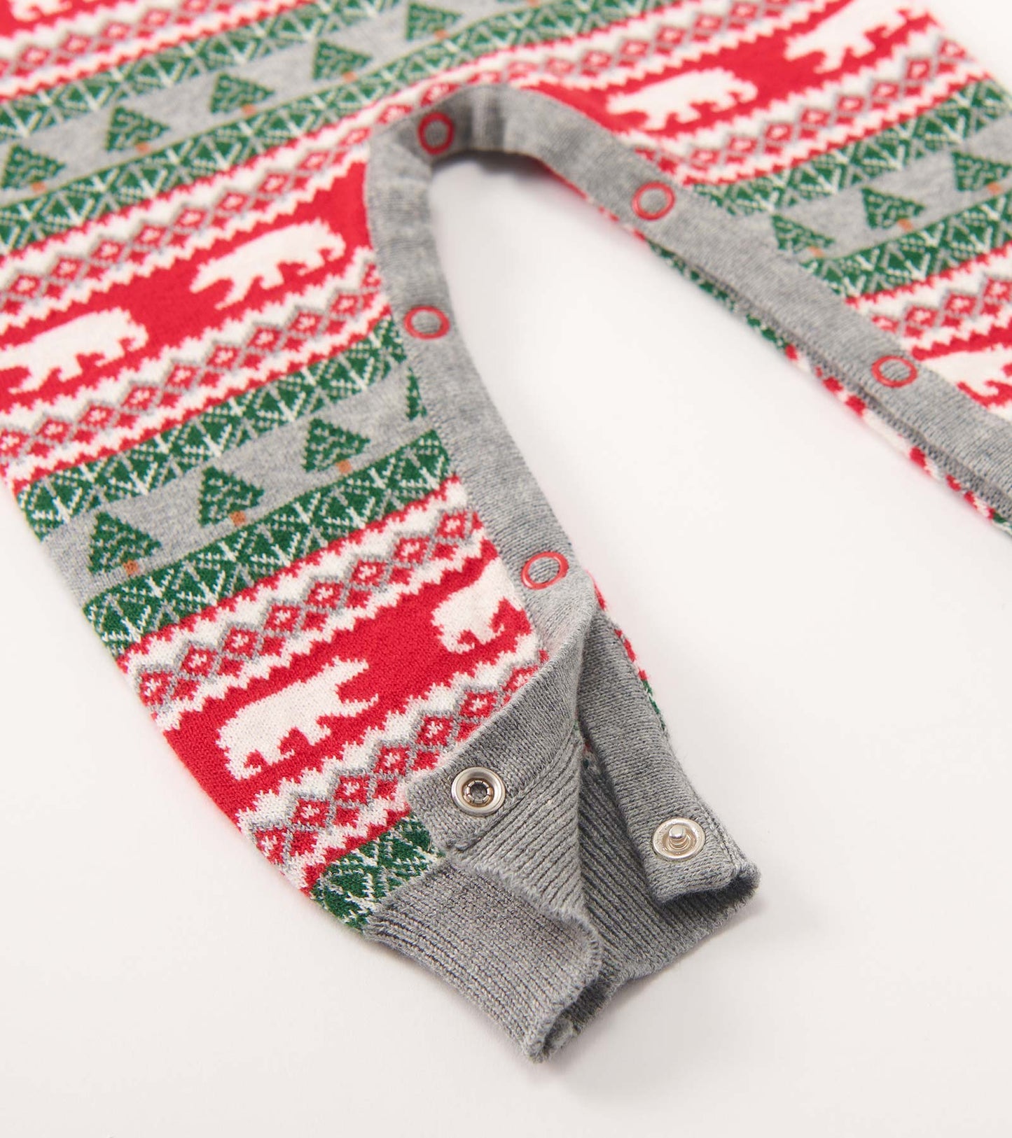 Red and green Fair Isle sweater romper featuring polar bears and trees, with gray trim and snap closures at the bottom.