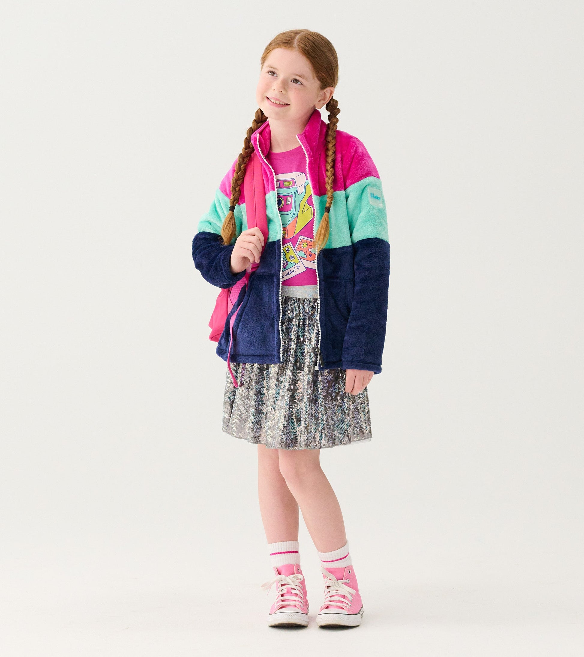 Fuzzy fleece zip-up jacket featuring colorblock stripes in pink, teal, and navy, worn by a girl with braids.