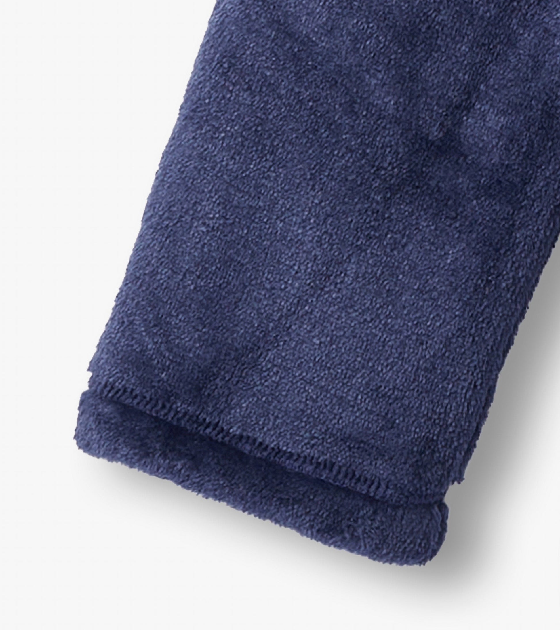 Navy fuzzy fleece fabric showcasing a soft texture, featuring a cuffed sleeve design.