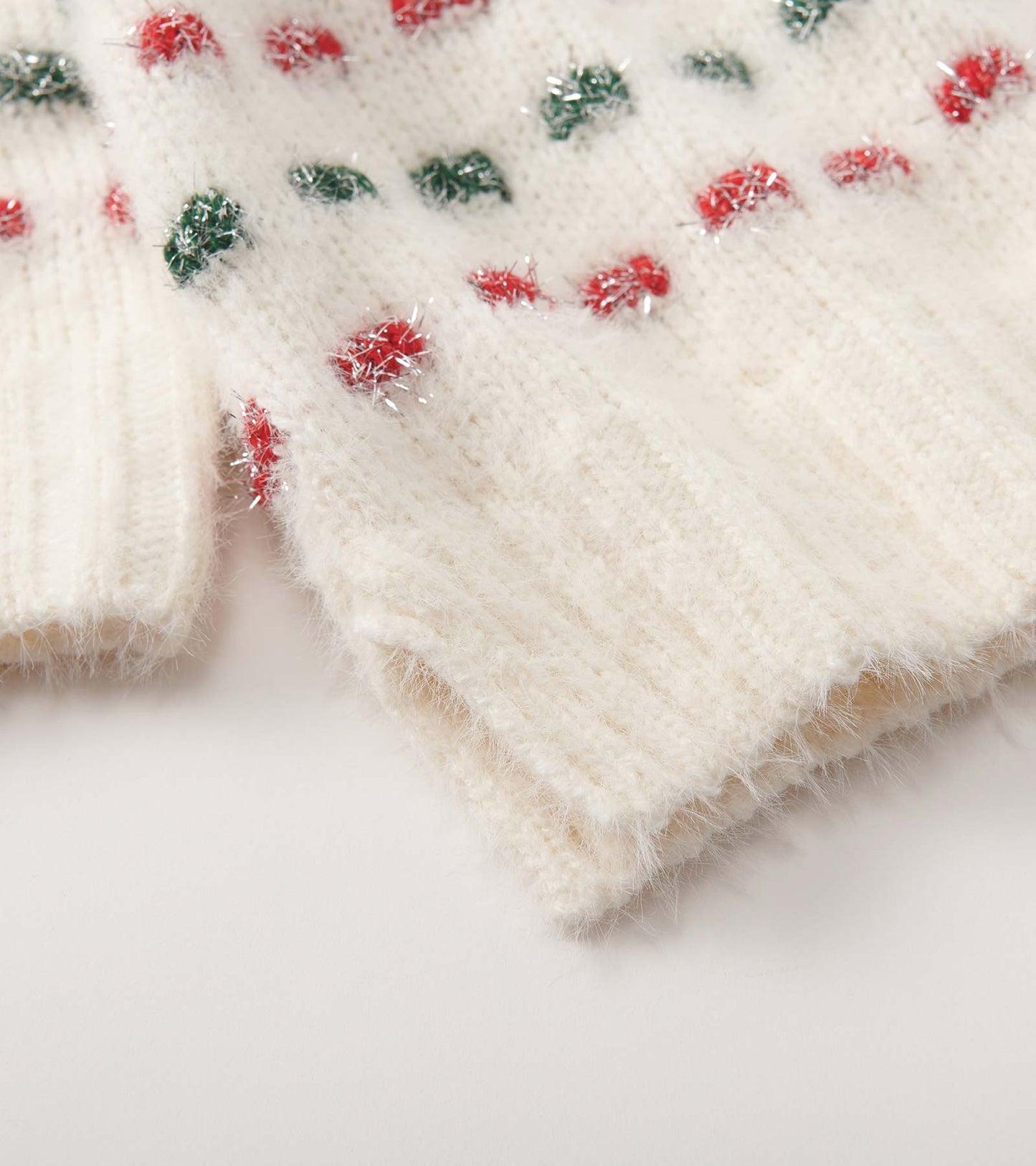 Cream sweater with a basket weave pattern, featuring colorful dots in red and green, made from a soft, fuzzy material.