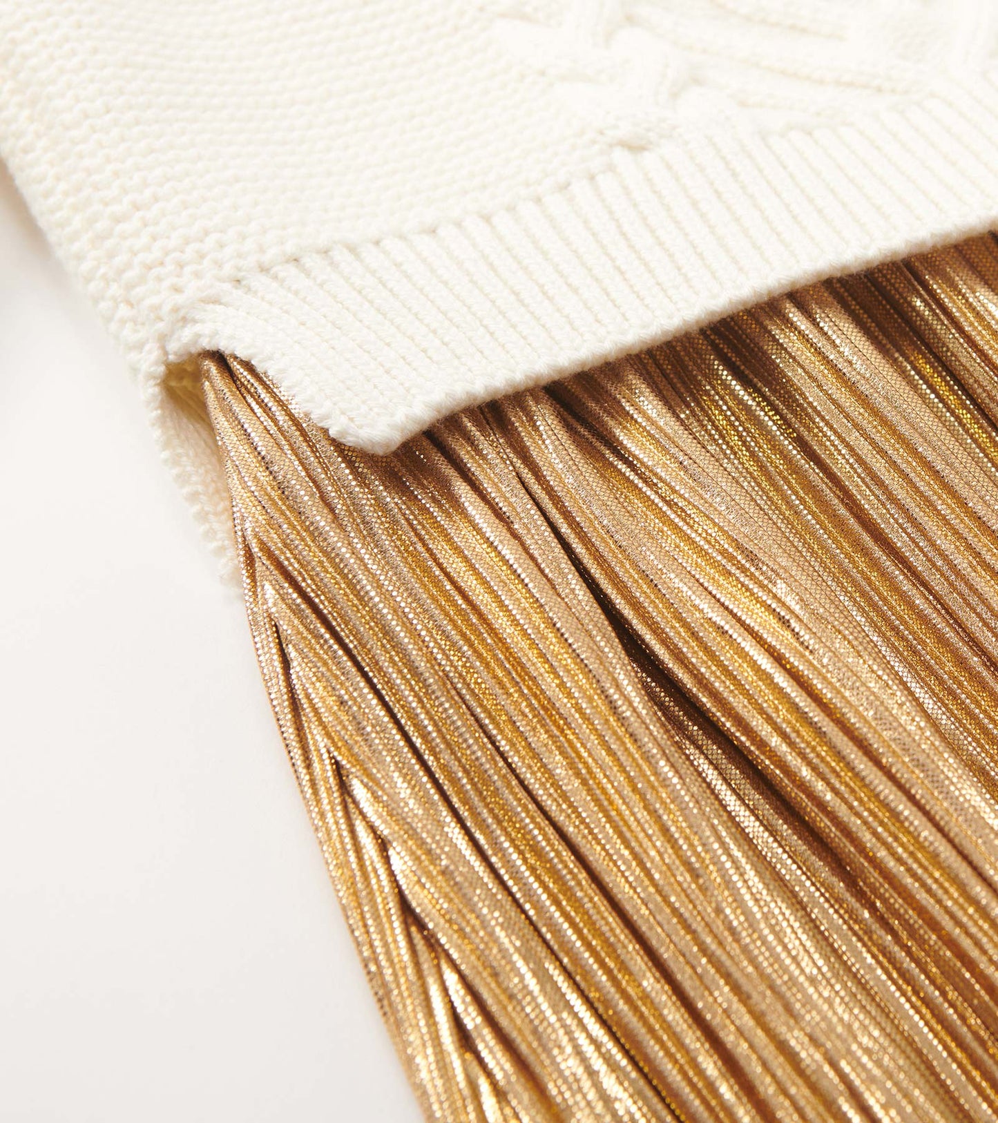 Cream top with textured knit and a flowing gold metallic fringe skirt. Suitable for holiday occasions.