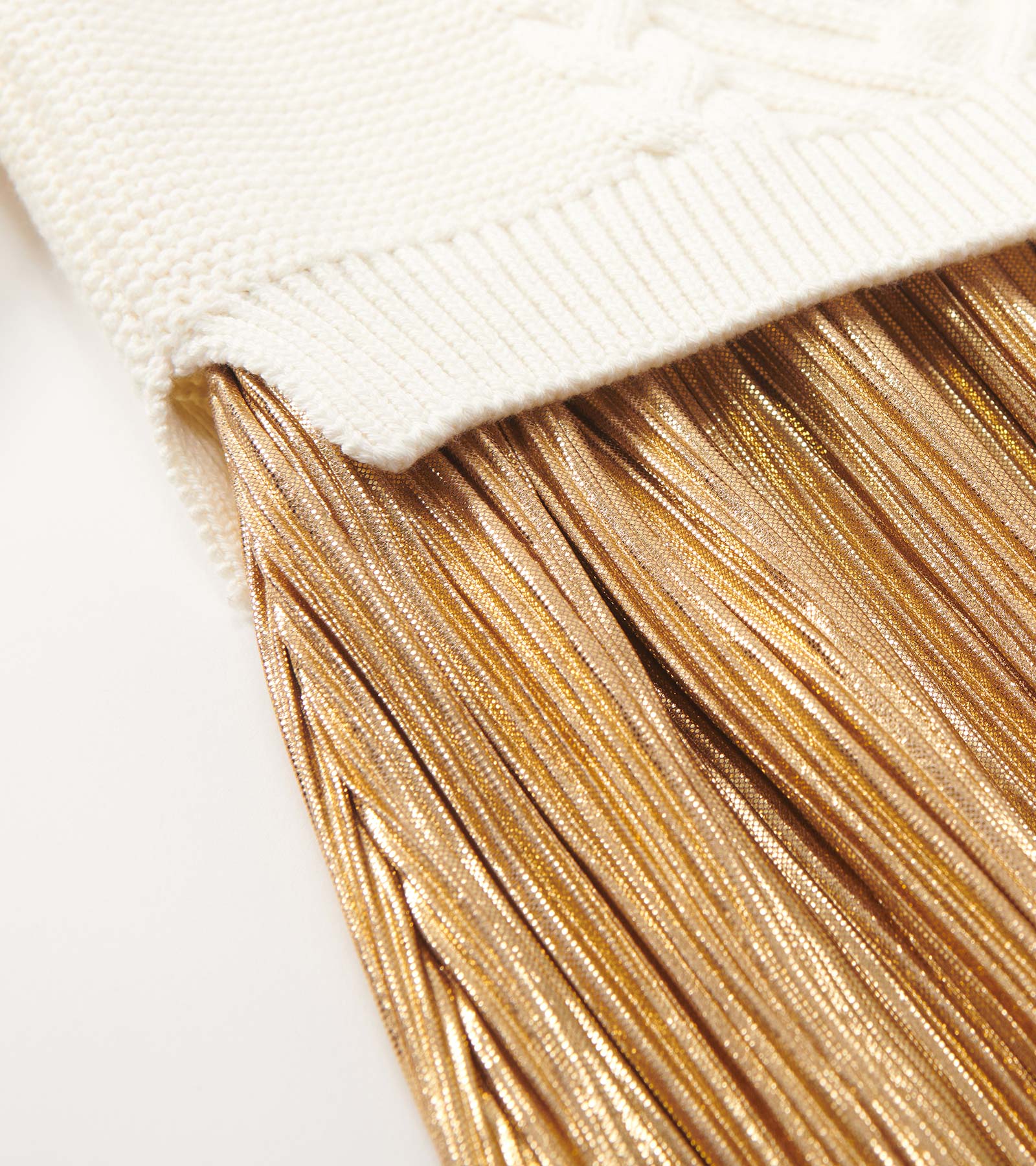 Cream top with textured knit and a flowing gold metallic fringe skirt. Suitable for holiday occasions.
