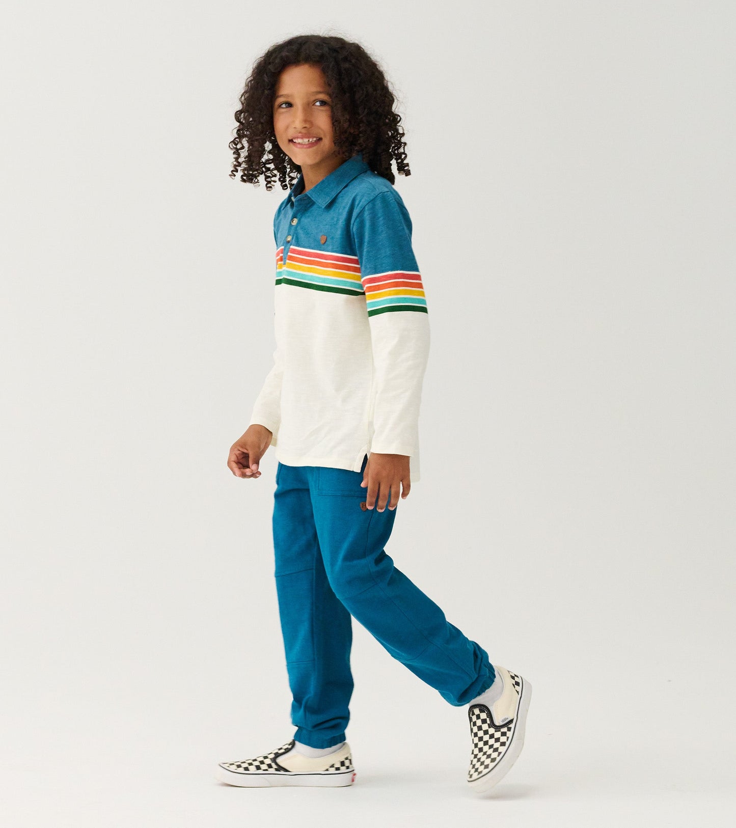Long sleeve polo with blue top and white bottom, featuring colorful retro stripes, paired with blue pants and checkered shoe…