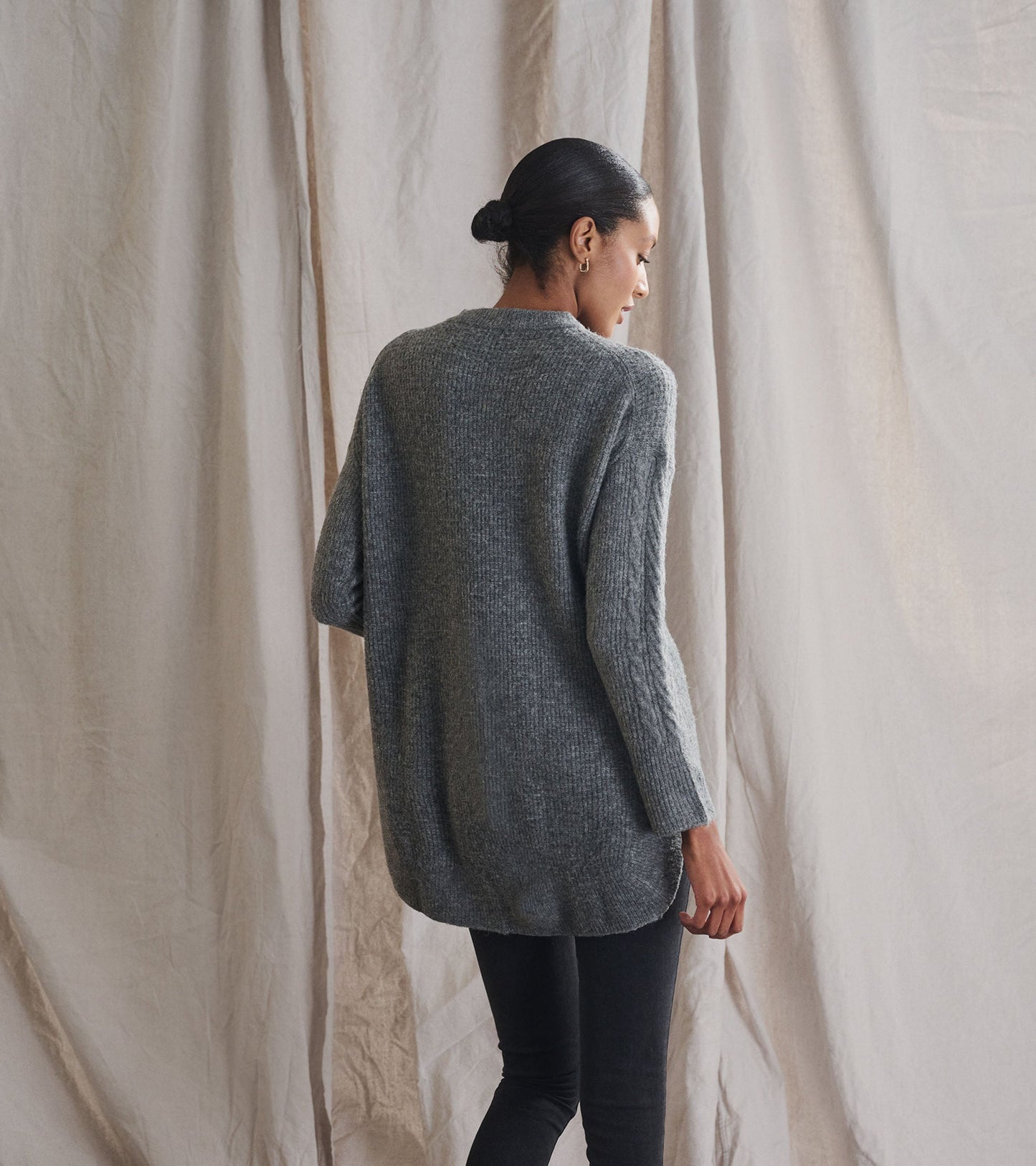 Charcoal heather cable knit tunic with long sleeves and a relaxed fit, shown from the back.