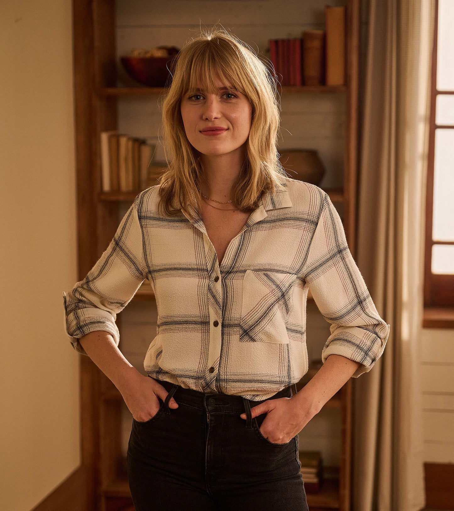 Cream plaid button-down shirt with a relaxed fit and rolled sleeves, featuring a front pocket.