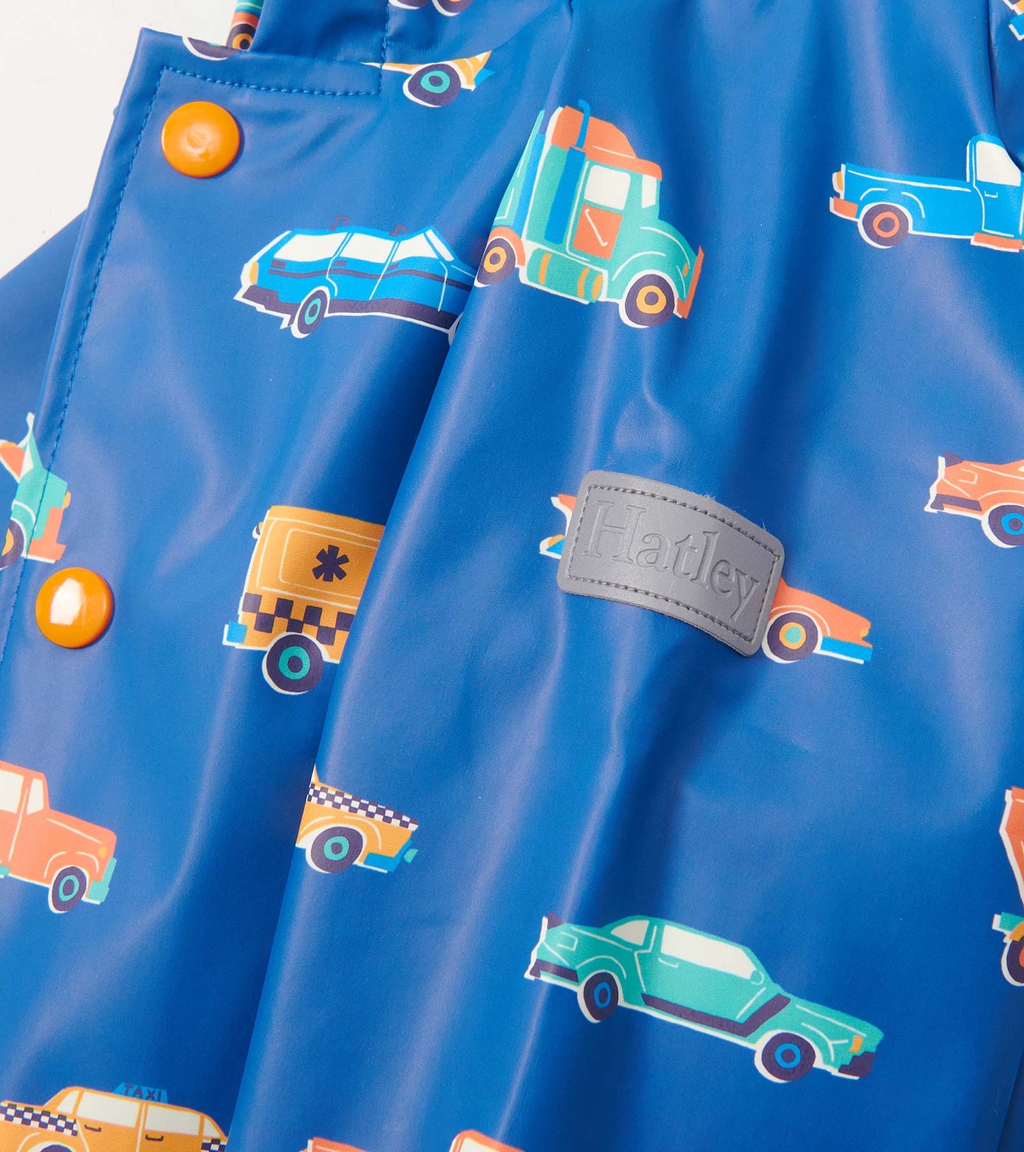 Blue rain jacket featuring colorful car patterns and orange buttons, suitable for baby and toddler boys.