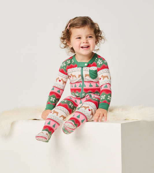 Colorful footed sleeper featuring puppy and heart patterns, with a green collar and cuffs, designed for infants.