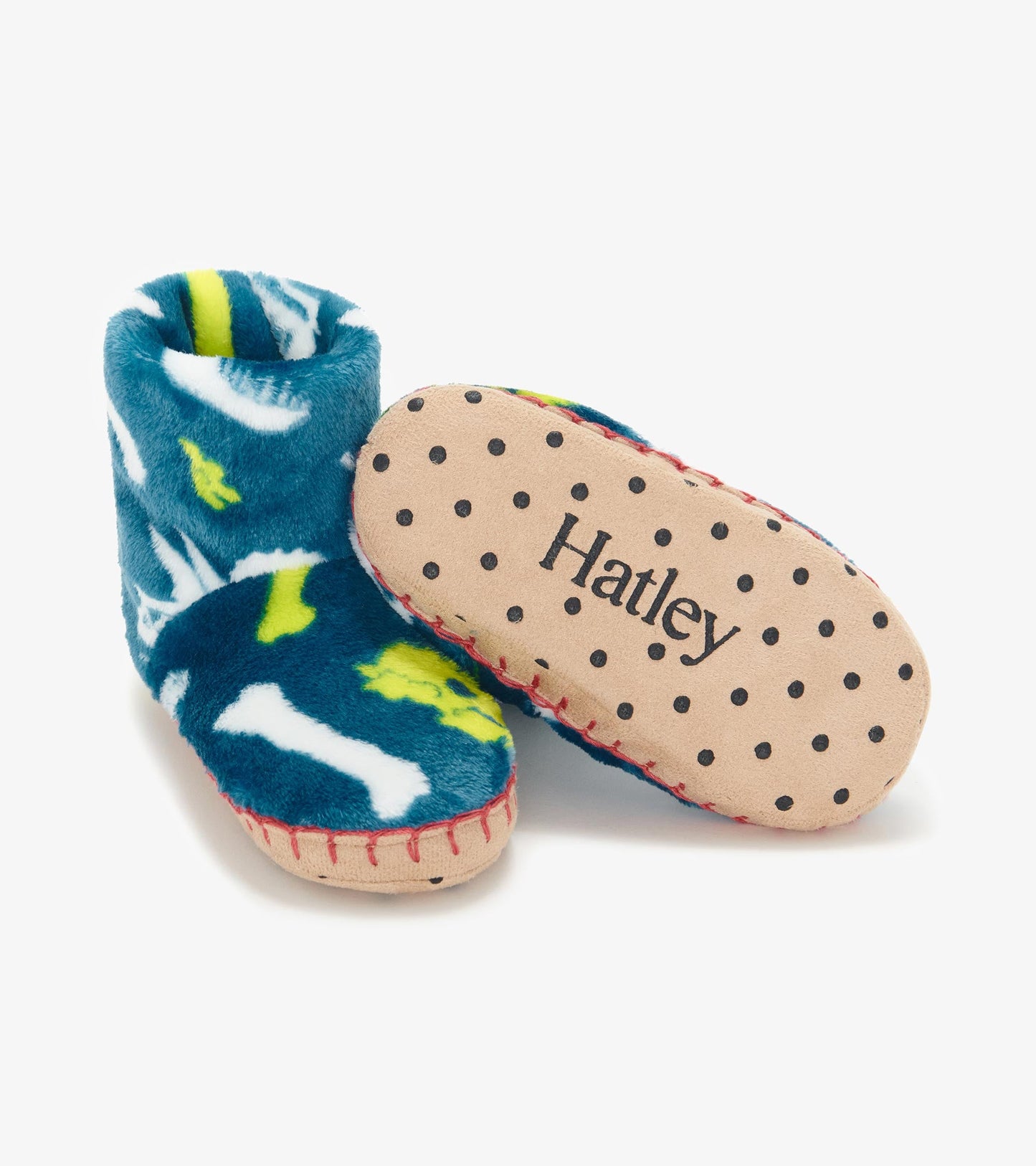 Blue fleece slippers featuring dinosaur fossil patterns, with a soft sole and stitched detailing.