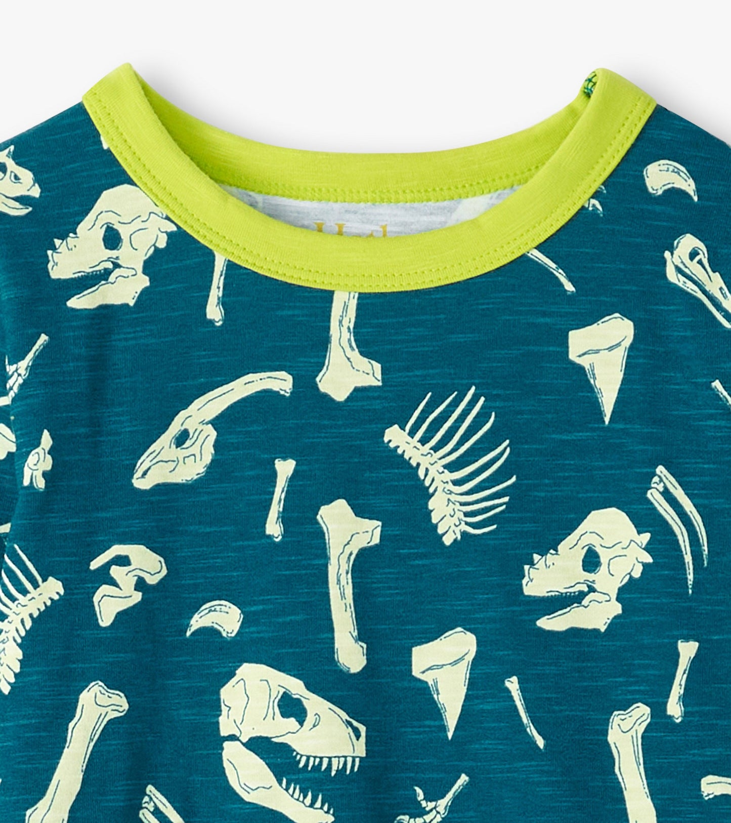 Teal pajama top featuring a dinosaur fossil print with a bright green collar.