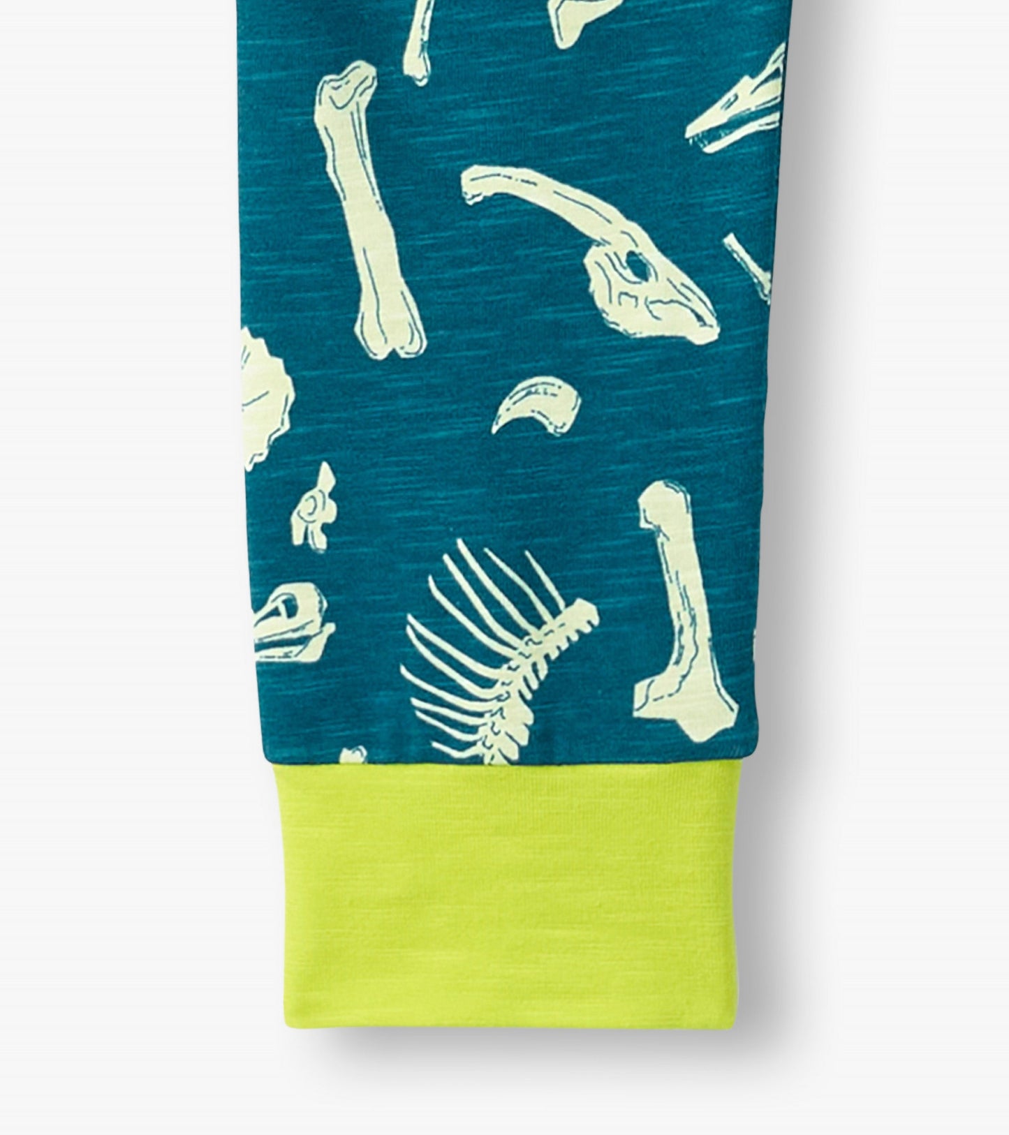 Teal pajama set featuring white dinosaur fossil prints and a bright yellow cuff, suitable for boys.