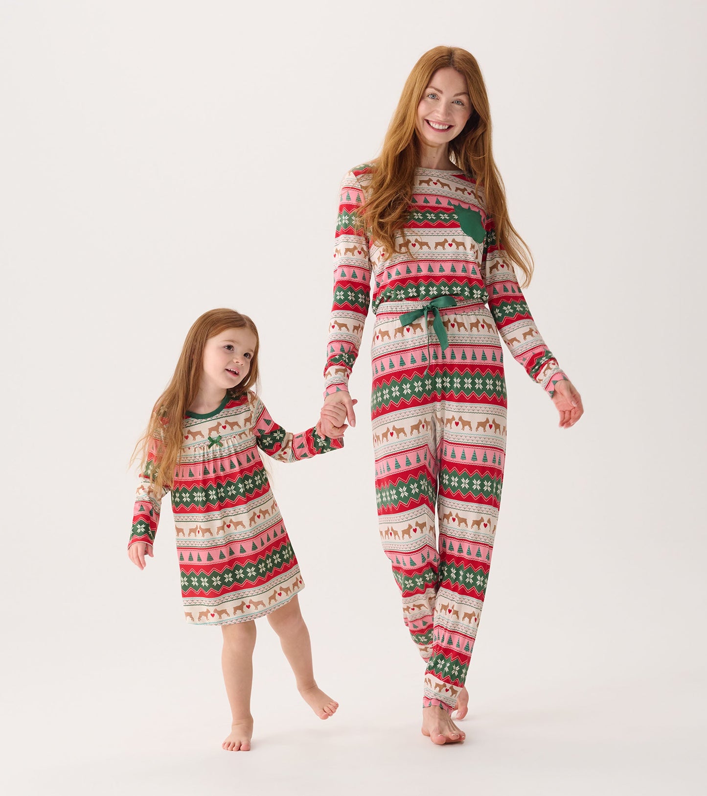 Women's bamboo pajama set featuring a festive puppy hearts Fairisle pattern in red, green, and cream, worn by a mother and d…