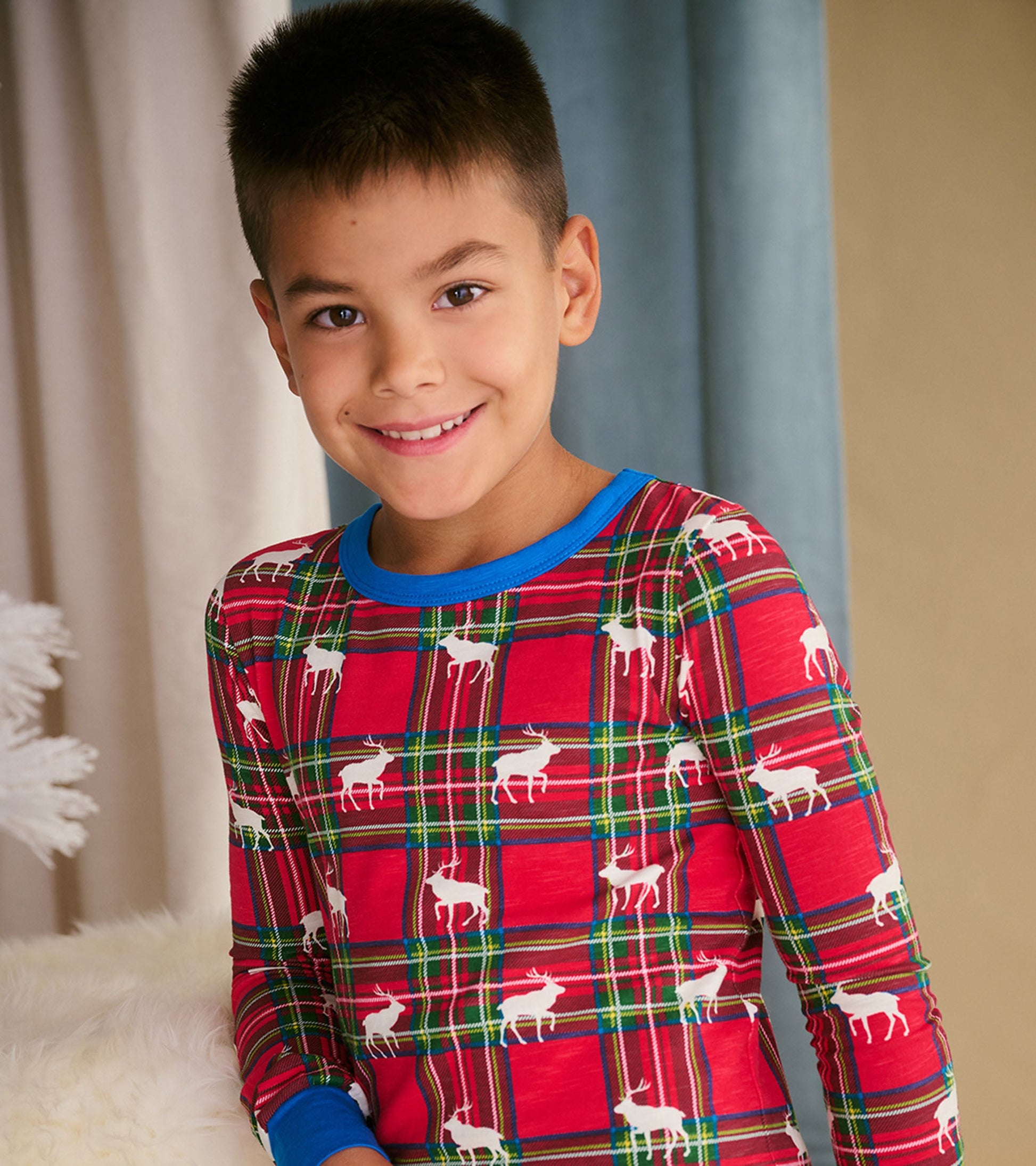 Red plaid pajama set featuring white elk silhouettes, with a blue collar and long sleeves, suitable for boys.