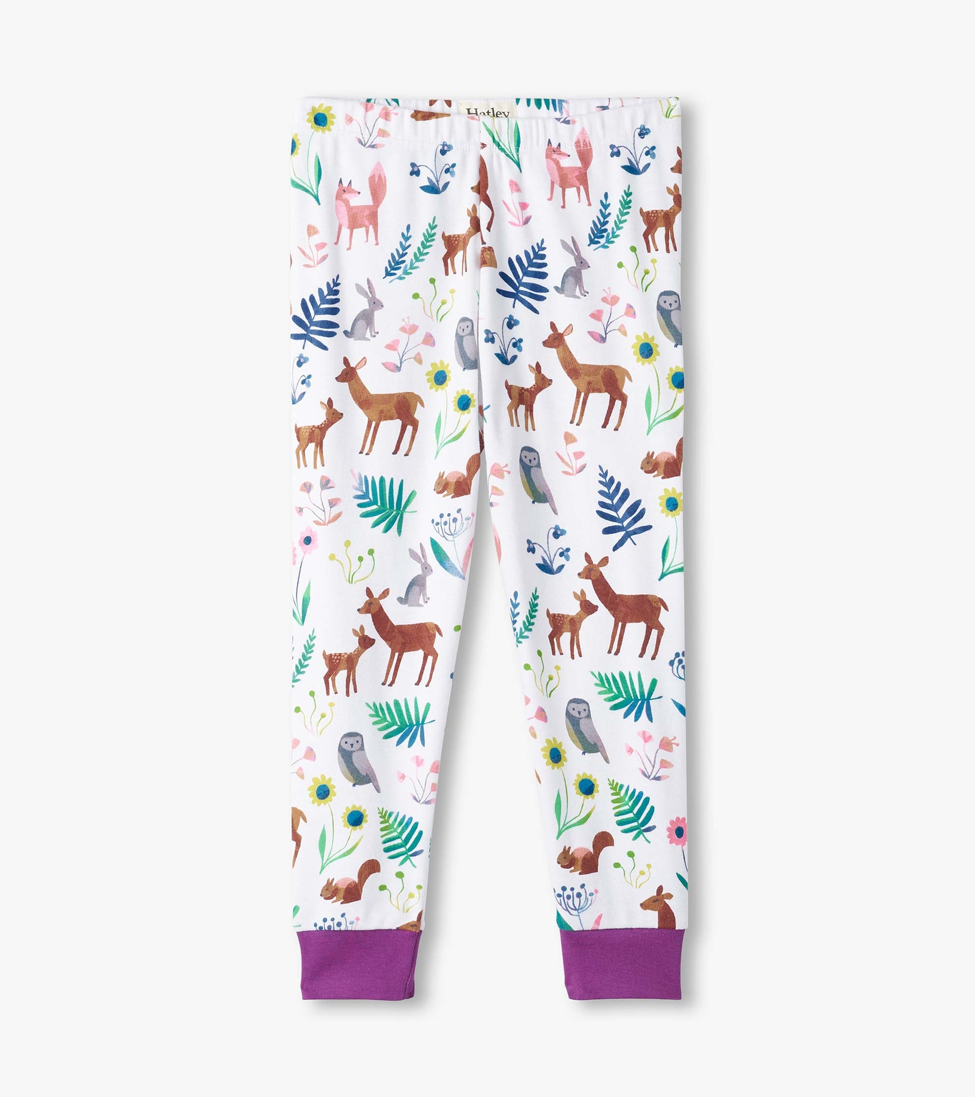 White pajama pants featuring colorful forest creature prints and purple cuffs, made from organic cotton.