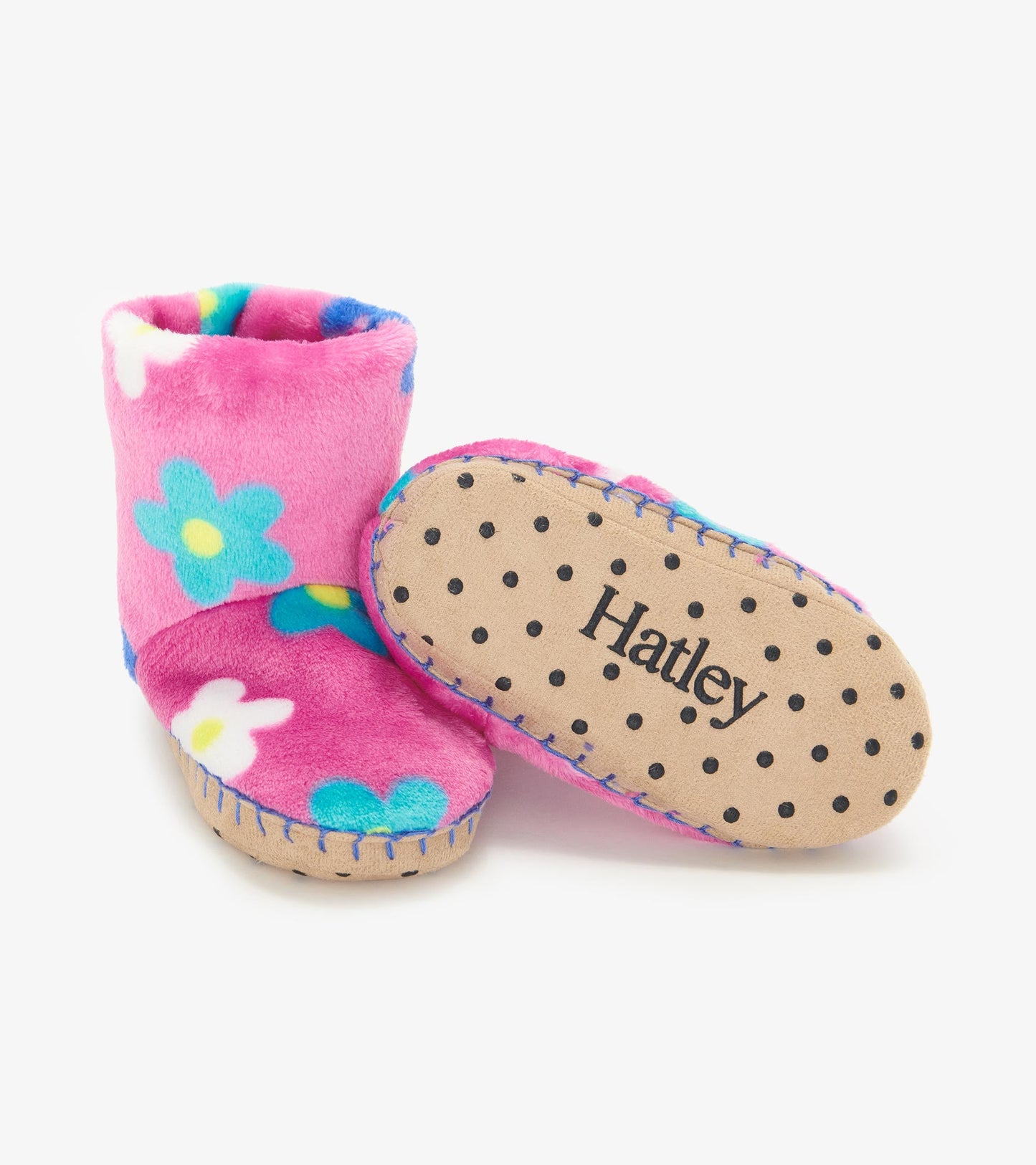Pink fleece slippers with colorful daisy patterns and a soft sole, ideal for keeping little feet warm and cozy.