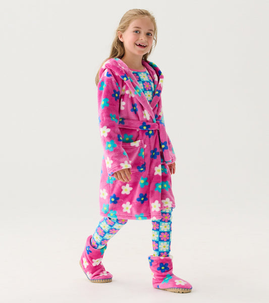Pink fleece robe with colorful daisy pattern, featuring a hood and belt, worn over matching floral leggings and slippers.