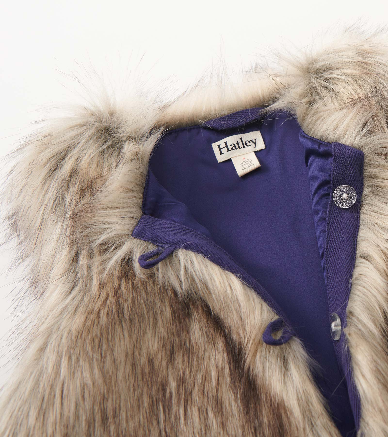 Faux fur vest with a soft, fluffy collar and a smooth inner lining, featuring button closures.