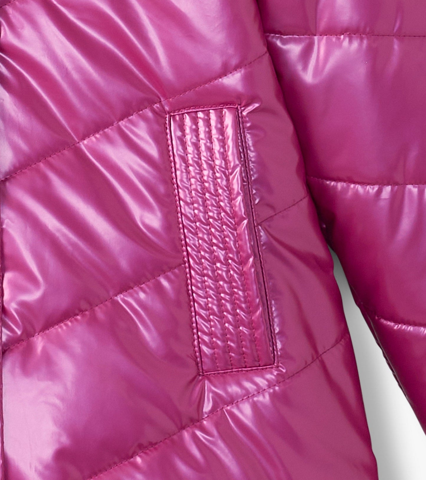 Fuschia puffer jacket with a shiny finish and quilted pattern, featuring a textured patch on the sleeve.