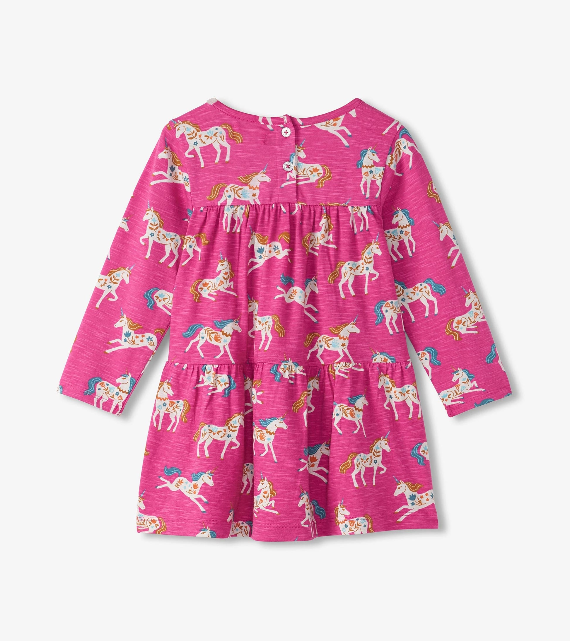 Pink gathered tiered dress featuring a whimsical unicorn print, long sleeves, and button closure at the back.