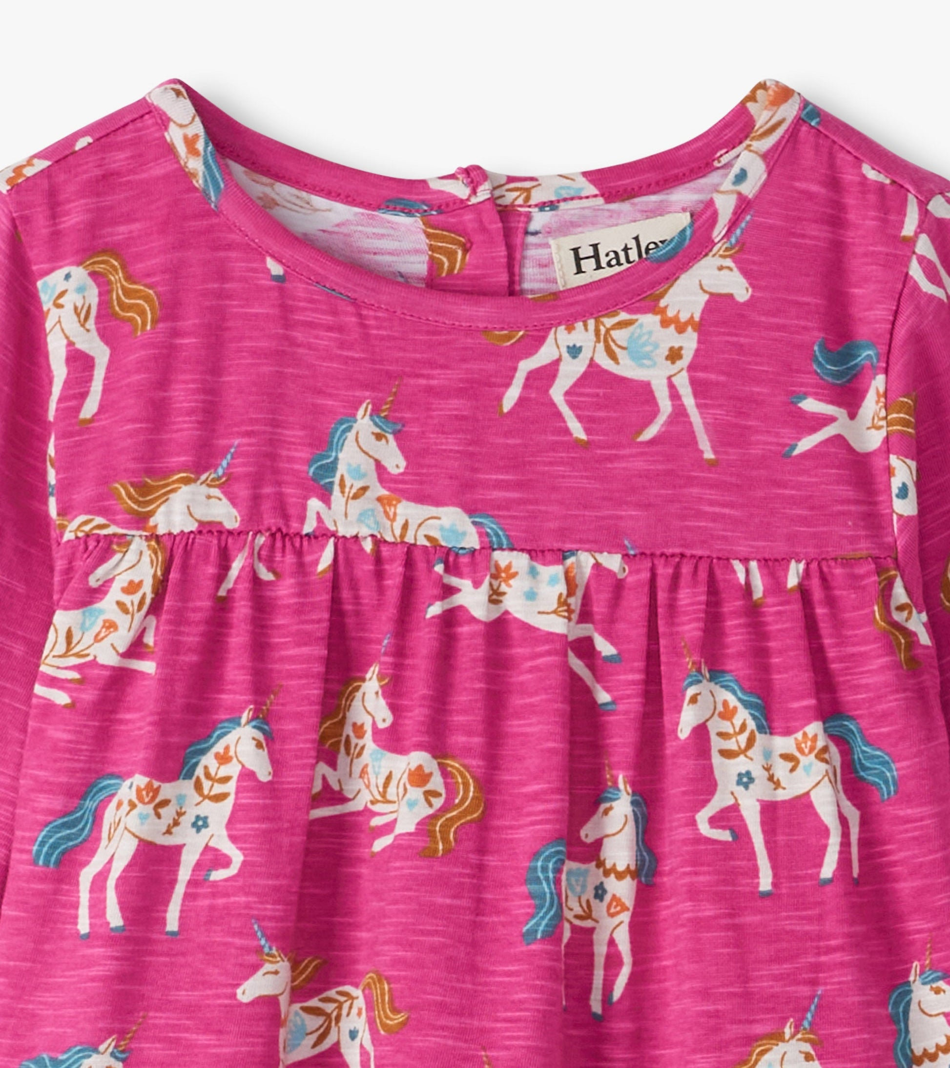 Pink gathered tiered dress featuring a whimsical unicorn print in various colors, suitable for baby and toddler girls.