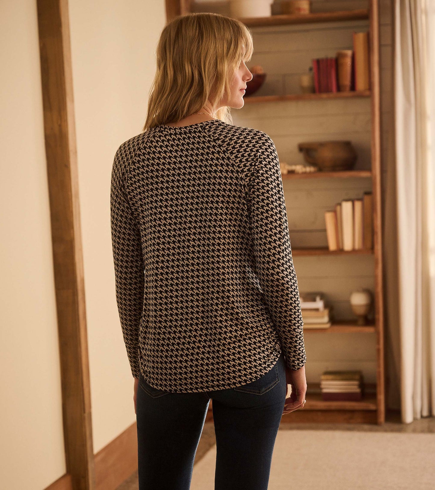 Back view of Chantel pullover in black and cream houndstooth with long sleeves and a curved hem