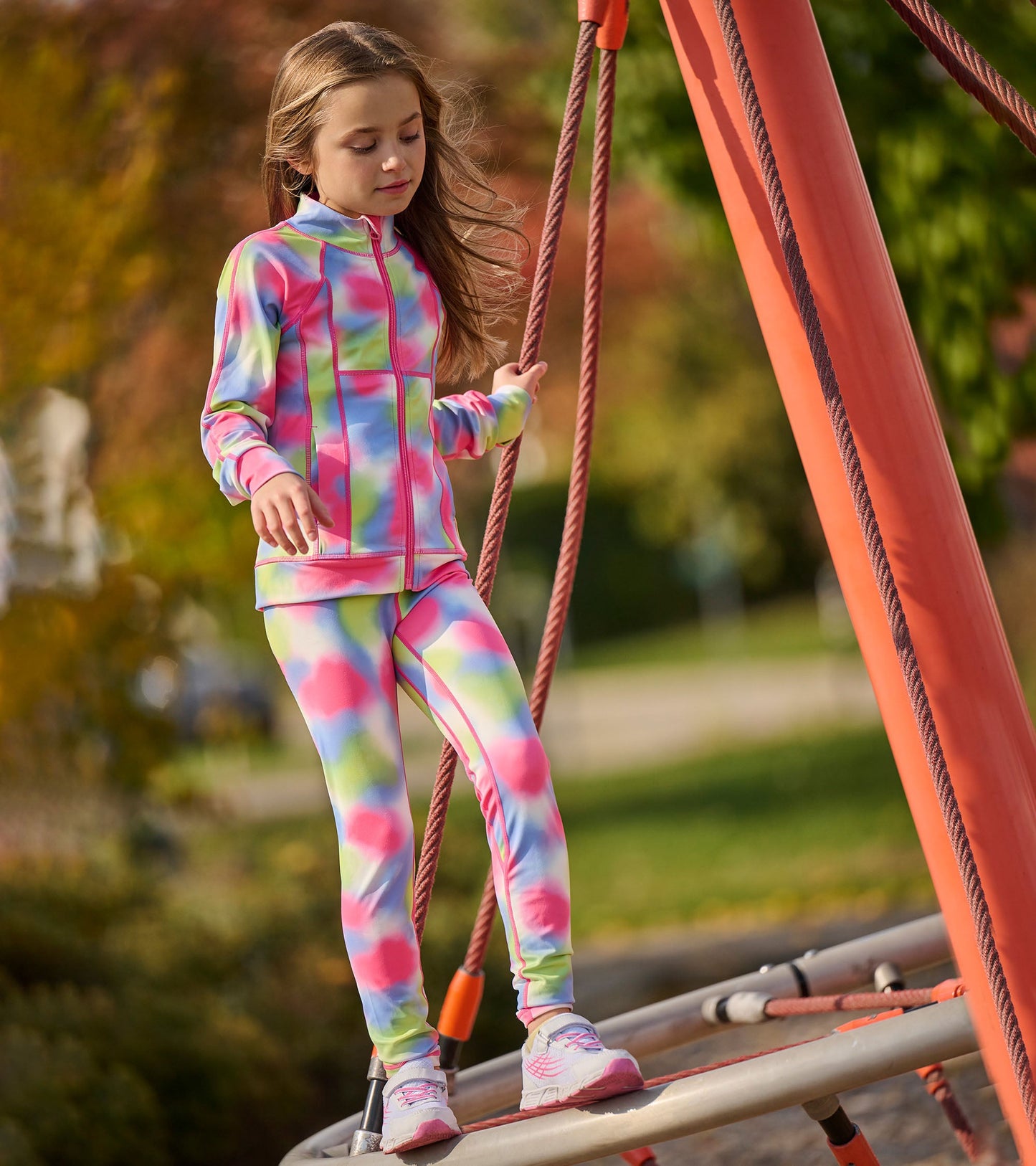 Colorful tie-dye active jacket with matching leggings, designed for girls, suitable for outdoor play.