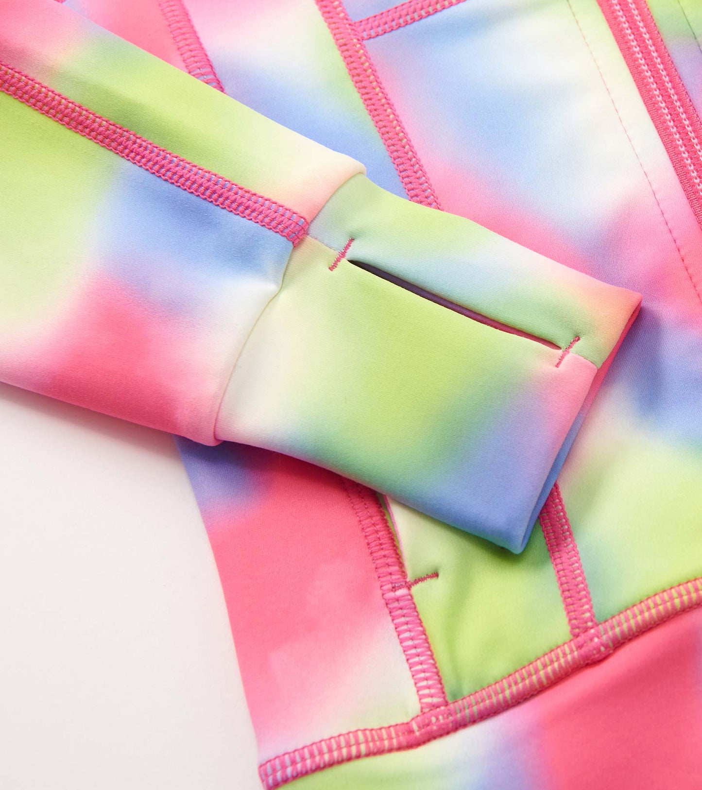 Colorful tie-dye active jacket featuring pink, green, and blue hues with a soft, stretchy material and thumbholes.